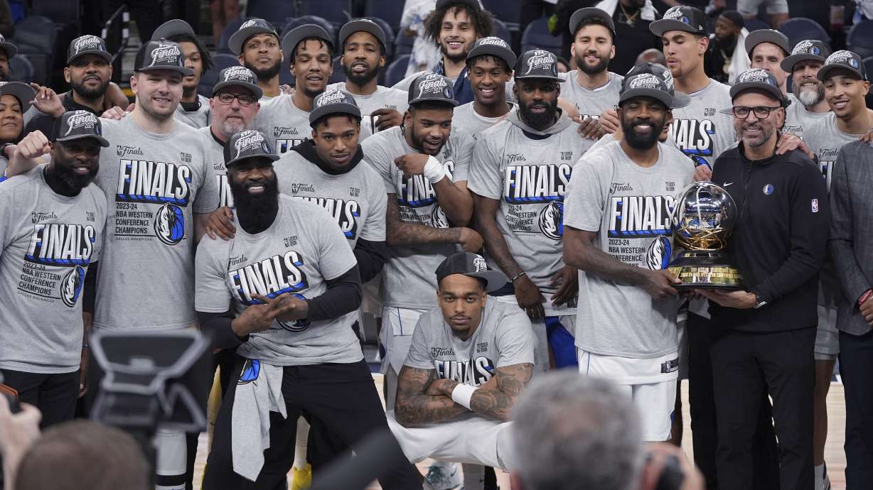 The Dallas Mavericks pose for a team photograph after a win over the Minnesota Timberwolves in Game 5 of the Western Conference finals in the NBA basketball playoffs Thursday, May 30, 2024, in Minneapolis. The Mavericks won 124-103, taking the series 4-1 and moving on to the NBA Finals.