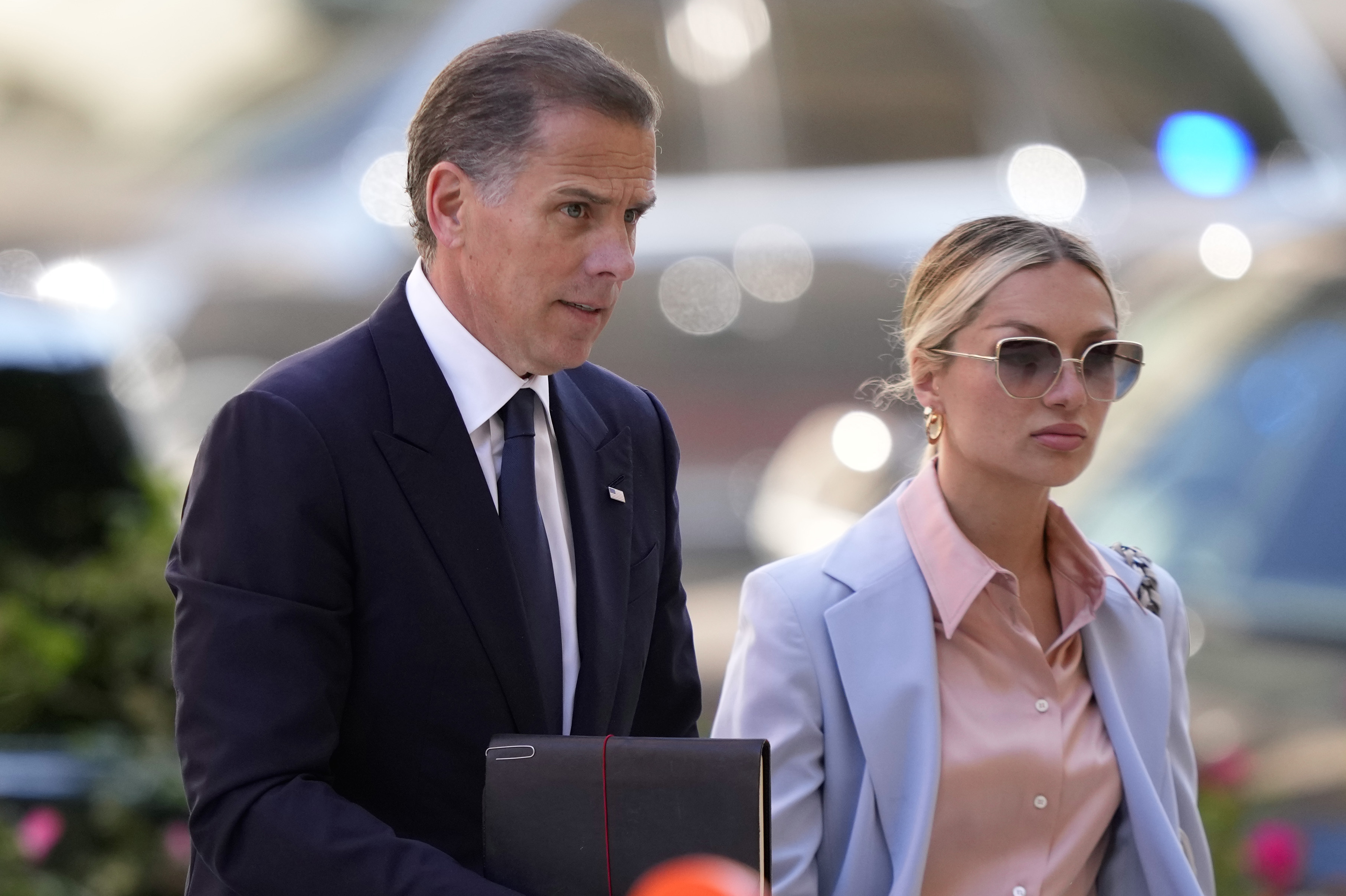 Hunter Biden, left, arrives with his wife, Melissa Cohen Biden at federal court, Tuesday, in Wilmington, Del., for his criminal trial on gun charges, ahead of opening statements and potentially lurid testimony.