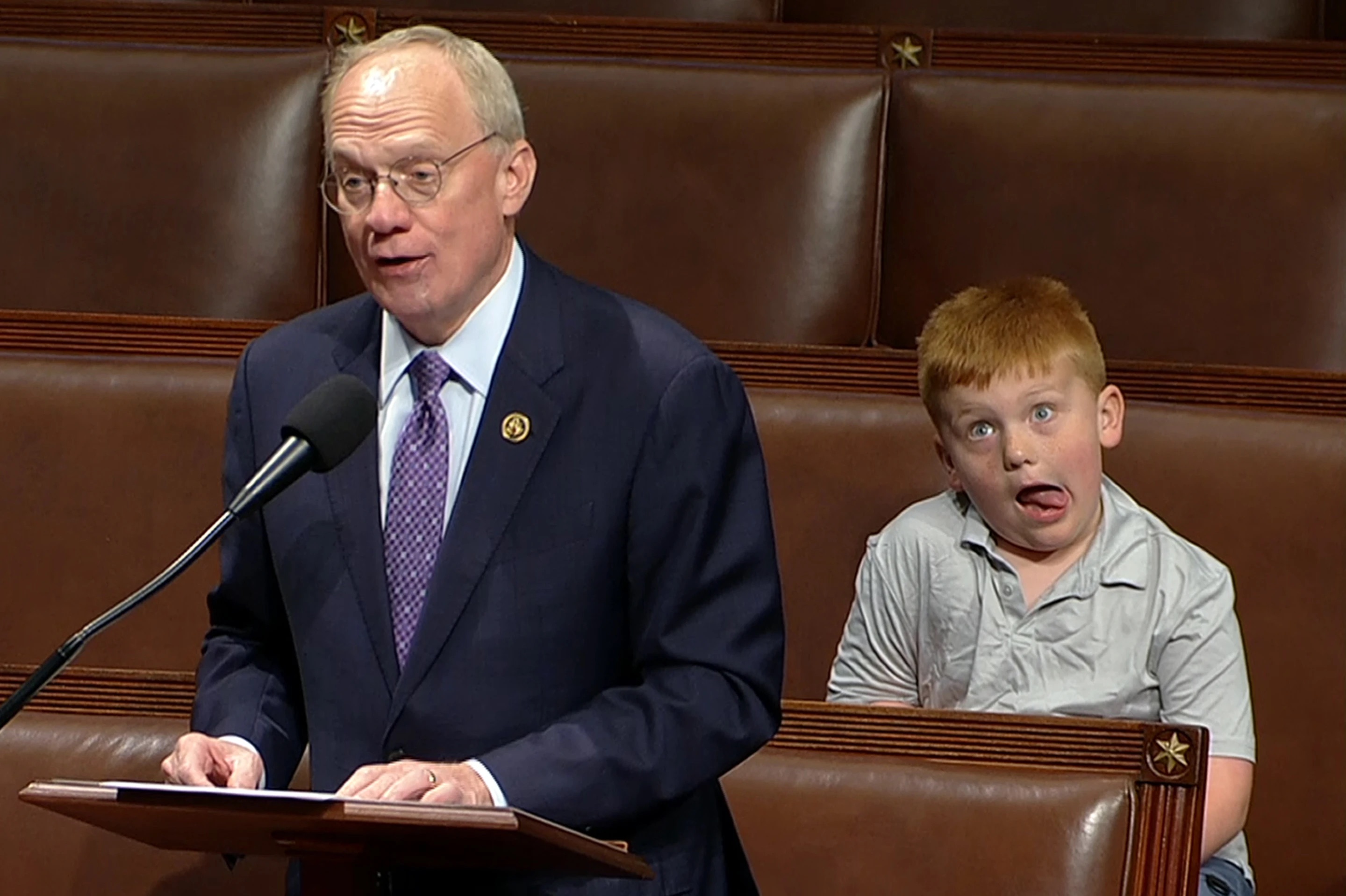Rep. John Rose, R-Tenn., speaks on the floor of the House of Representatives Monday in Washington, as his son Guy makes a face.