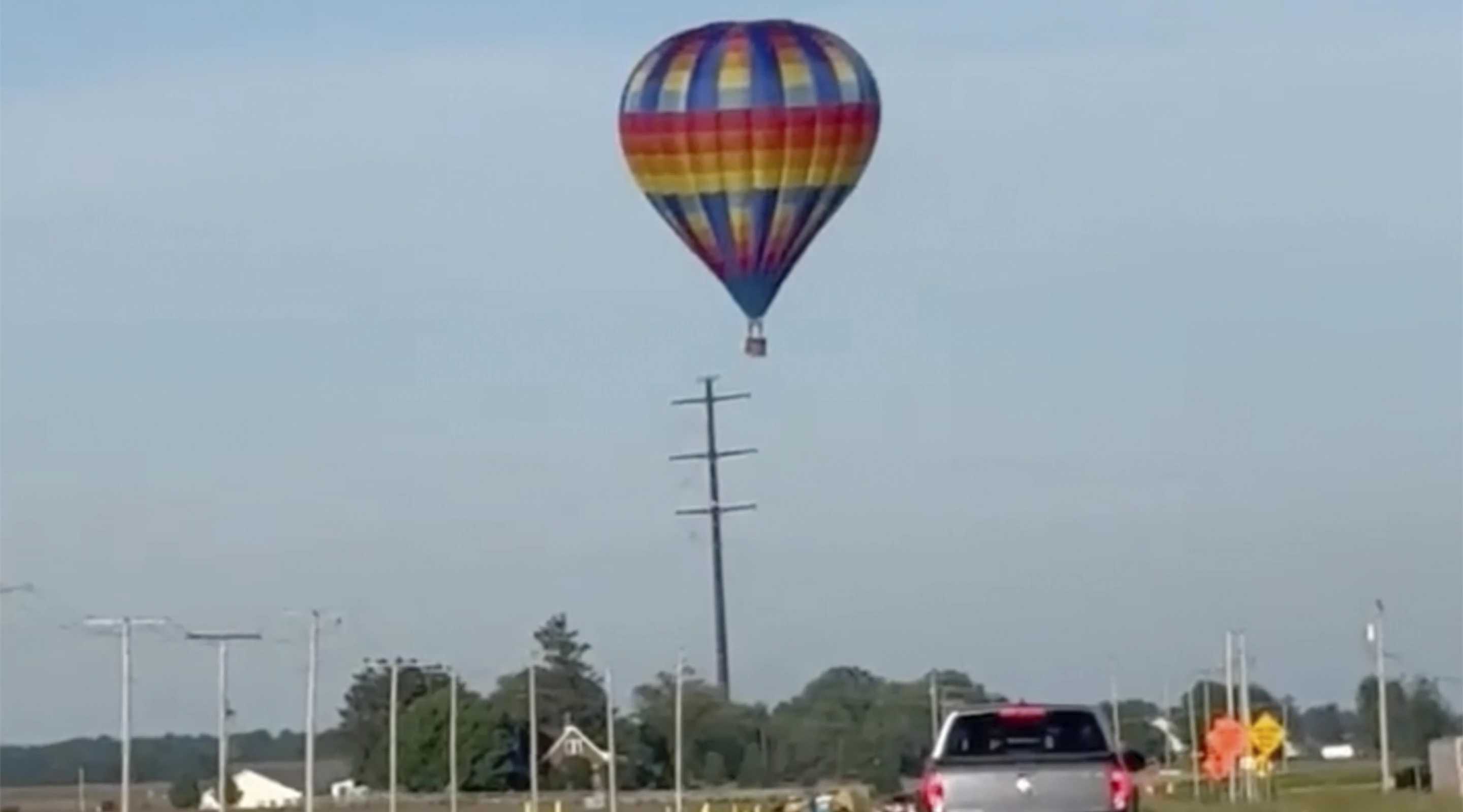This photo shows a hot air balloon crashing after hitting a utility pole on Sunday east of Lowell, Ind. Federal investigators are probing the crash that injured three people.