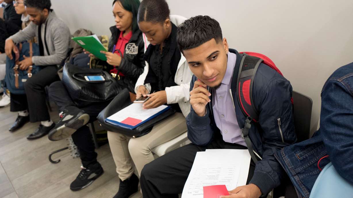 Young job seekers attend a job fair hosted by the Gregory Jackson Center for Brownsville, Nov. 15, 2016, in New York. For many young Americans entering the workforce, finding a job at all would seem like a win.