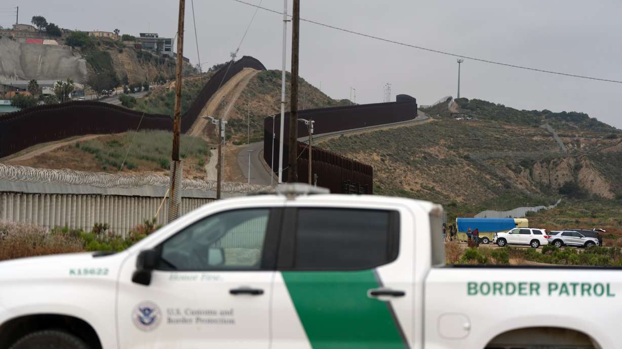A Border Patrol vehicle sits near border walls separating Tijuana, Mexico, from the United States, Tuesday, in San Diego.