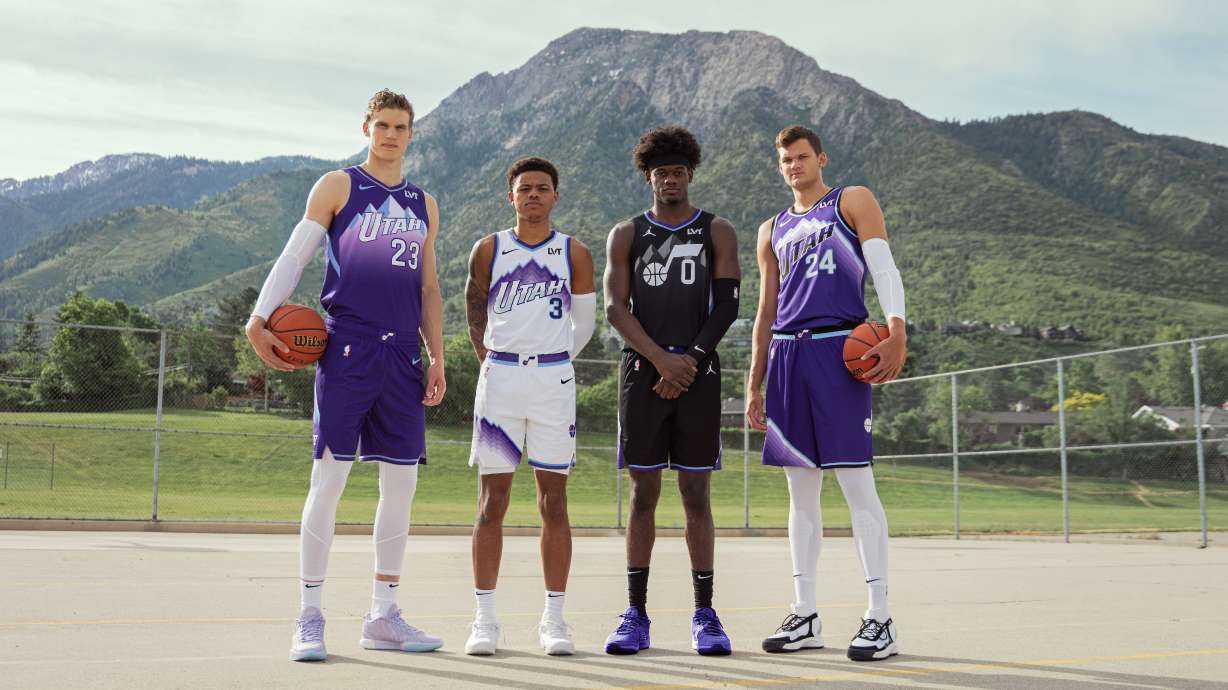 Jazz players pose in new "Mountain Basketball" uniforms.