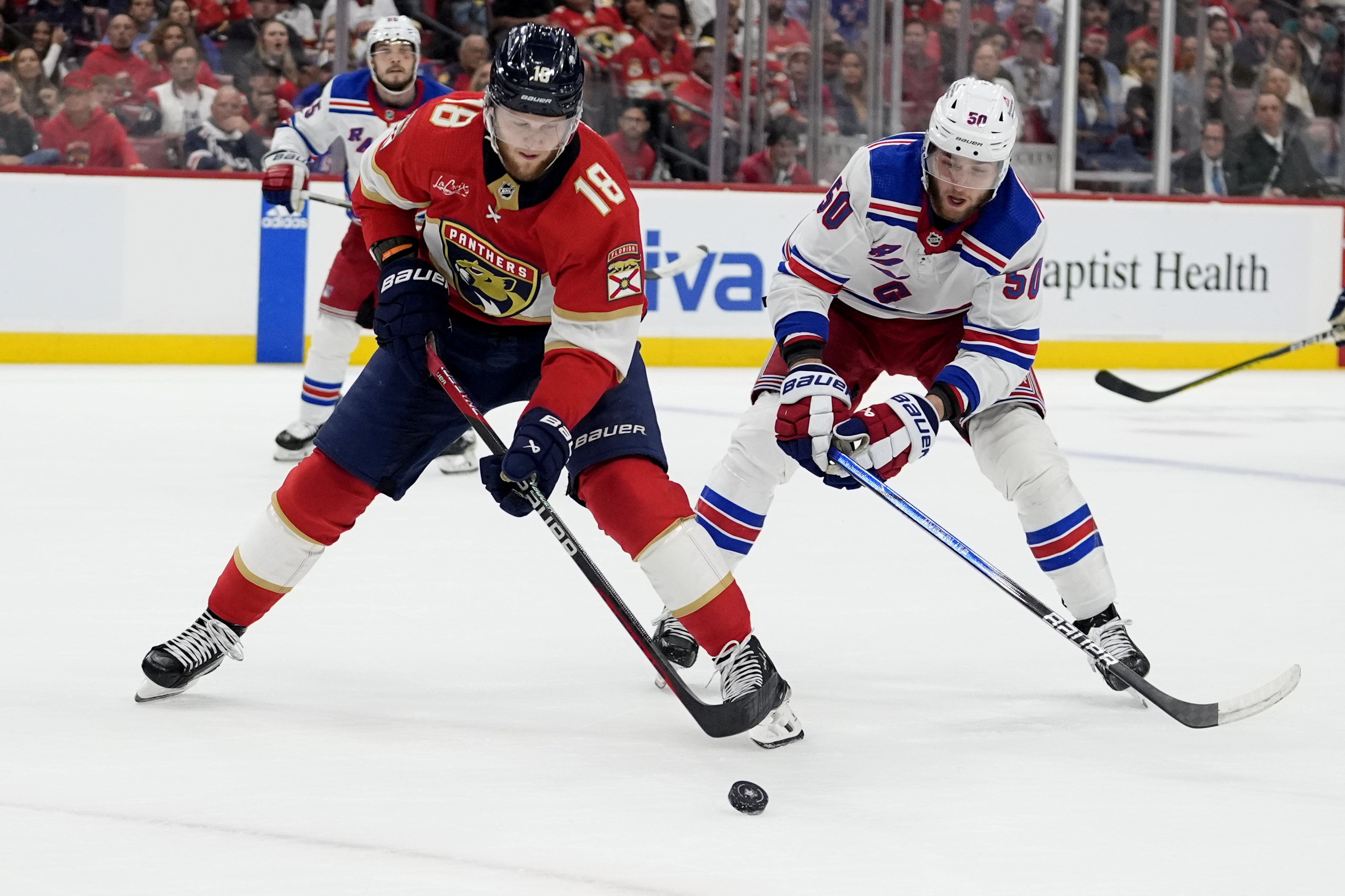 Florida Panthers center Steven Lorentz (18) skates with the puck as New York Rangers left wing Will Cuylle (50) defends during the second period of Game 6 in the Eastern Conference finals of the NHL hockey Stanley Cup playoffs Saturday, June 1, 2024, in Sunrise, Fla. 