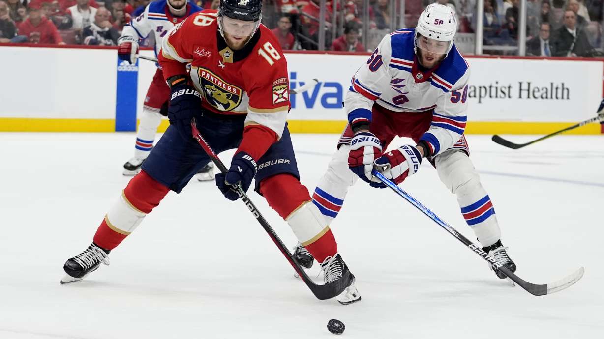 Florida Panthers center Steven Lorentz (18) skates with the puck as New York Rangers left wing Will Cuylle (50) defends during the second period of Game 6 in the Eastern Conference finals of the NHL hockey Stanley Cup playoffs Saturday, June 1, 2024, in Sunrise, Fla.