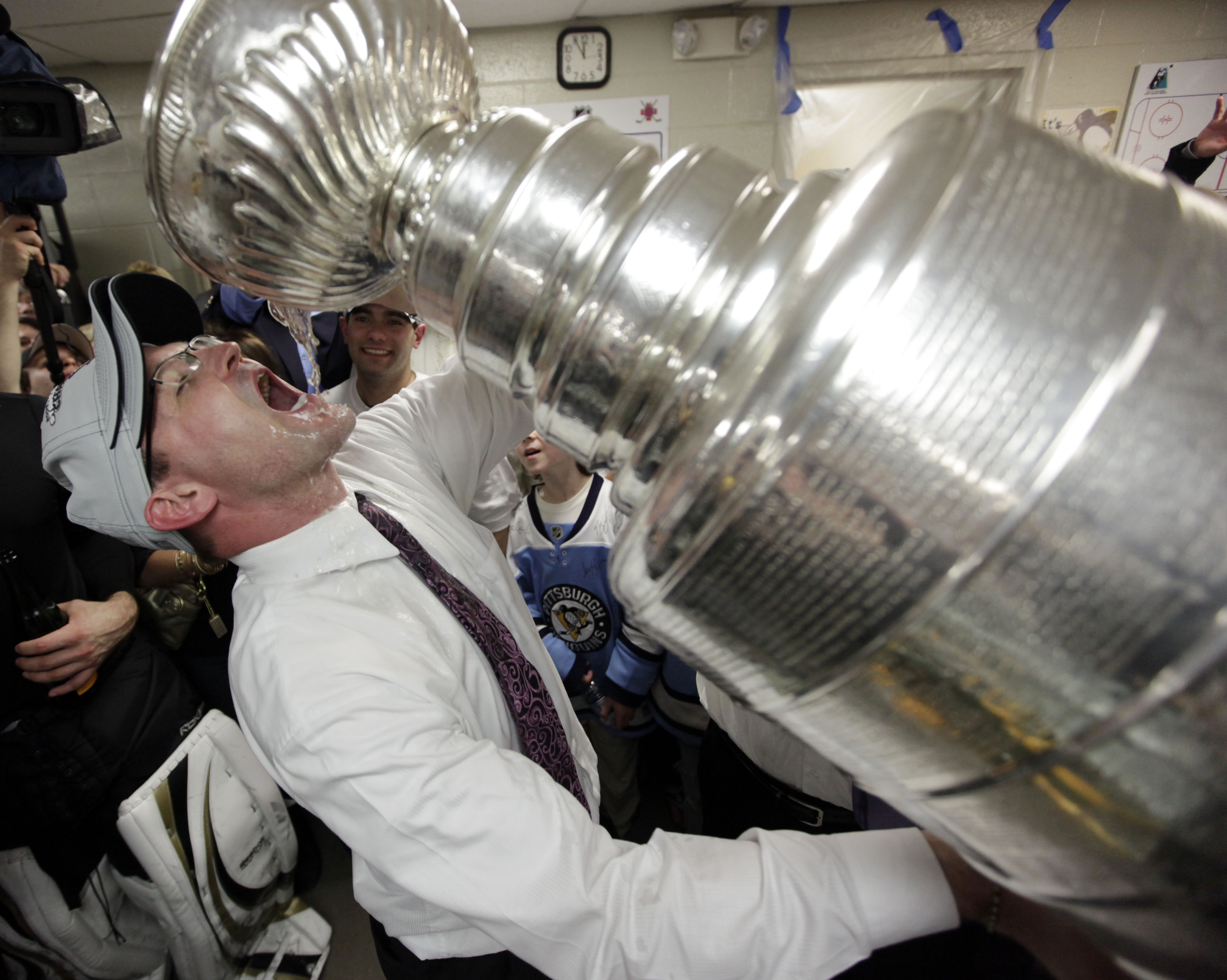 FILE - Pittsburgh Penguins coach Dan Bylsma drinks from the Stanley Cup after the Penguins defeated the Detroit Red Wings 2-1 to win Game 7 of the NHL hockey Stanley Cup Finals in Detroit, June 12, 2009. After making it to the Stanley Cup Final in 2008, the Penguins were barely over .500 in February of the next season, leading GM Ray Shero to fire Michel Therrien and promote Bylsma from the AHL. The results were almost immediate. 
