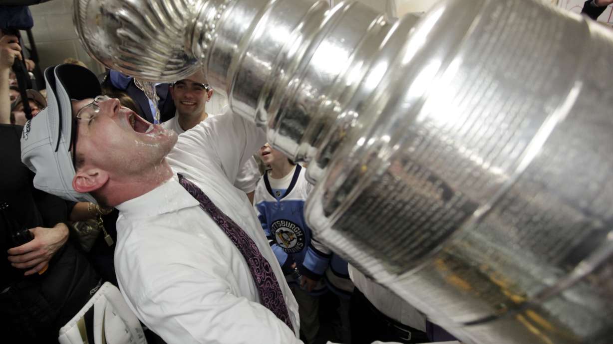 FILE - Pittsburgh Penguins coach Dan Bylsma drinks from the Stanley Cup after the Penguins defeated the Detroit Red Wings 2-1 to win Game 7 of the NHL hockey Stanley Cup Finals in Detroit, June 12, 2009. After making it to the Stanley Cup Final in 2008, the Penguins were barely over .500 in February of the next season, leading GM Ray Shero to fire Michel Therrien and promote Bylsma from the AHL. The results were almost immediate.