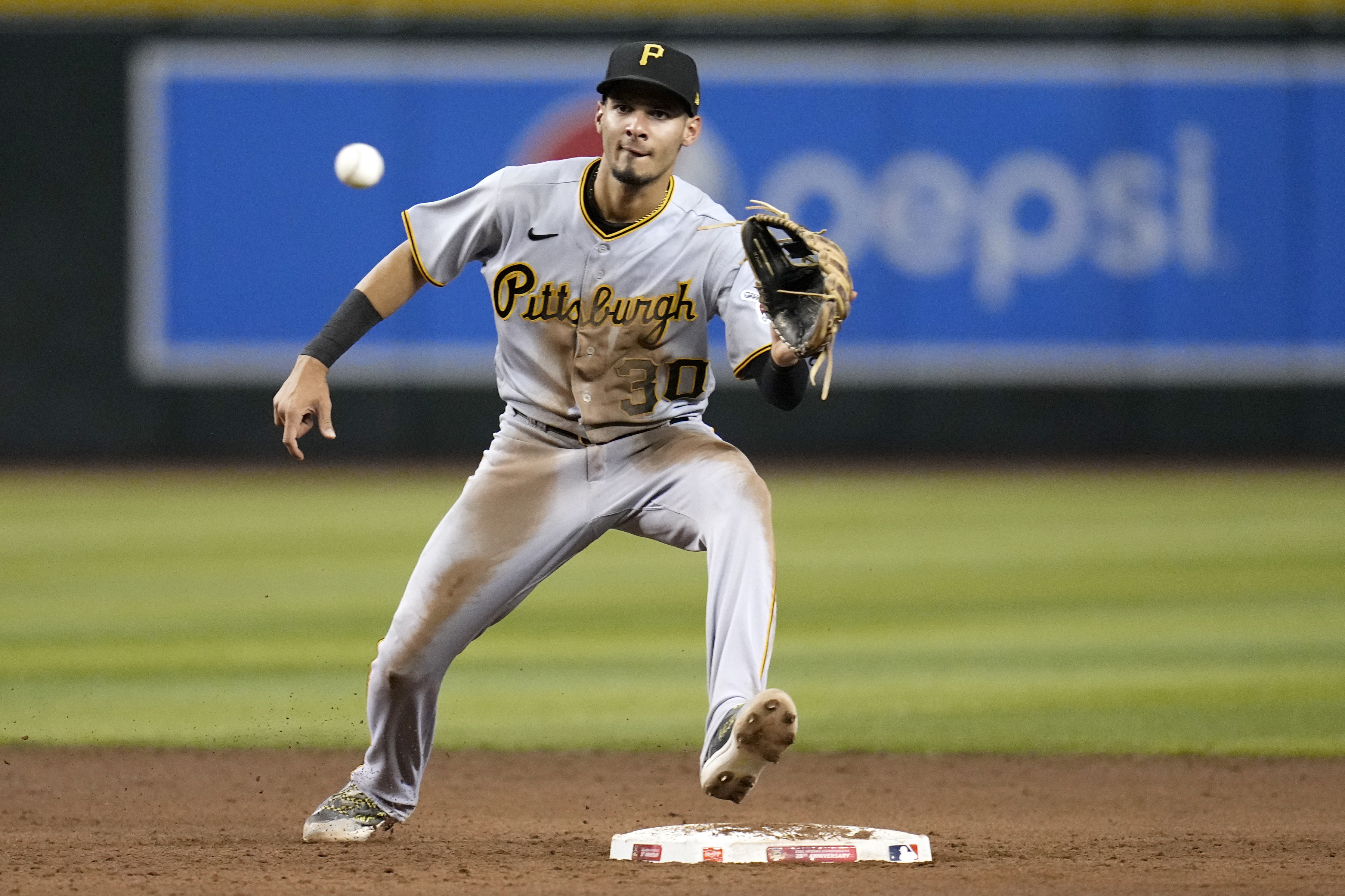 FILE - Pittsburgh Pirates shortstop Tucupita Marcano takes a throw down to second base during the fifth inning of a baseball game against the Arizona Diamondbacks, July 7, 2023, in Phoenix. Major League Baseball has permanently banned Marcano, Tuesday, June 4, 2024, for betting on baseball and suspended the four other players for one year after finding the players placed unrelated bets with a legal sportsbook. 
