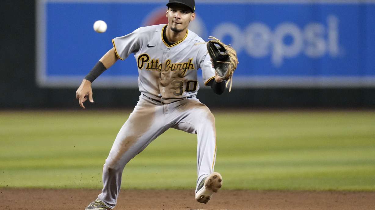 FILE - Pittsburgh Pirates shortstop Tucupita Marcano takes a throw down to second base during the fifth inning of a baseball game against the Arizona Diamondbacks, July 7, 2023, in Phoenix. Major League Baseball has permanently banned Marcano, Tuesday, June 4, 2024, for betting on baseball and suspended the four other players for one year after finding the players placed unrelated bets with a legal sportsbook.