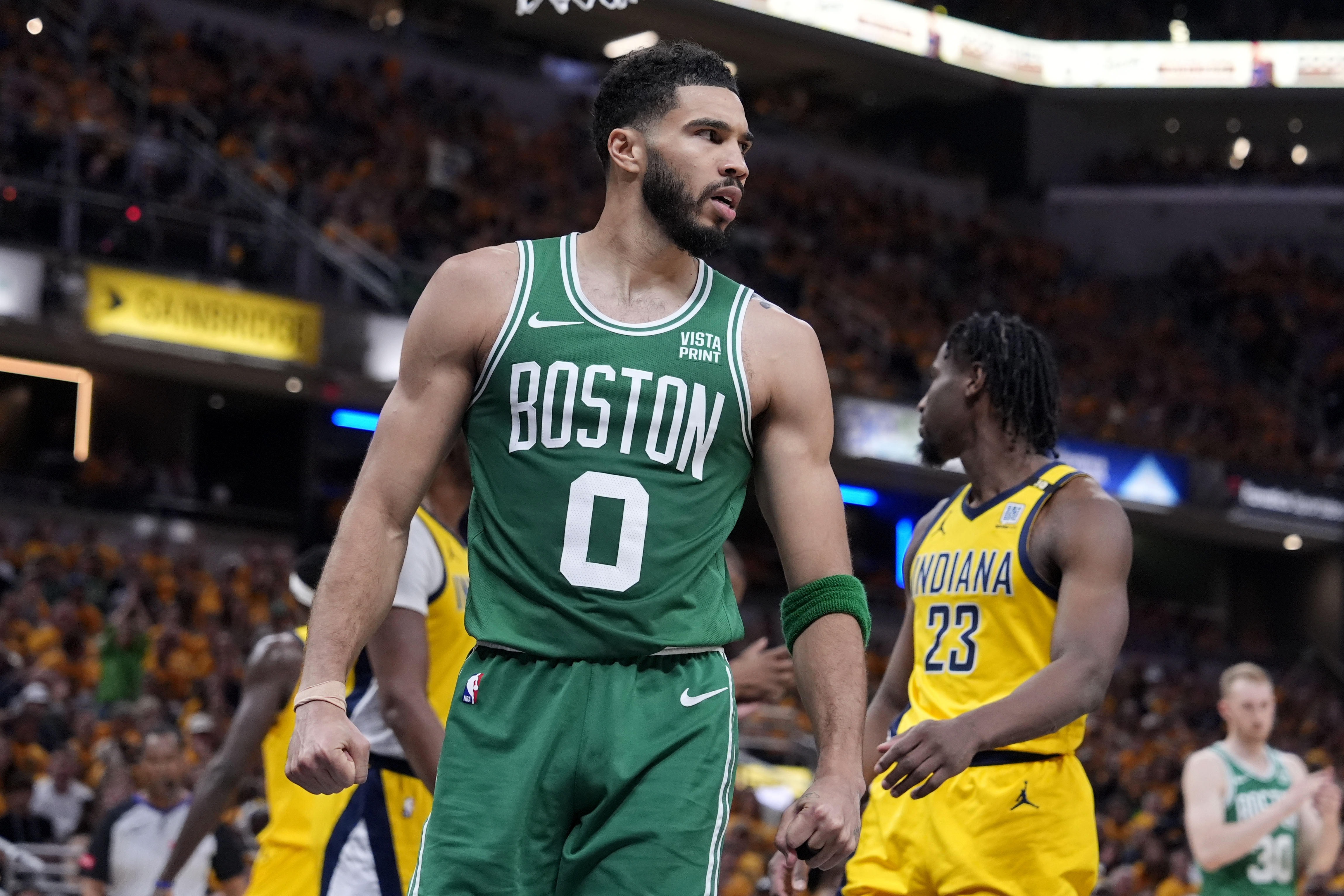 Boston Celtics forward Jayson Tatum (0) reacts after making a basket during the first half of Game 4 of the NBA Eastern Conference basketball finals against the Indiana Pacers, Monday, May 27, 2024, in Indianapolis. 