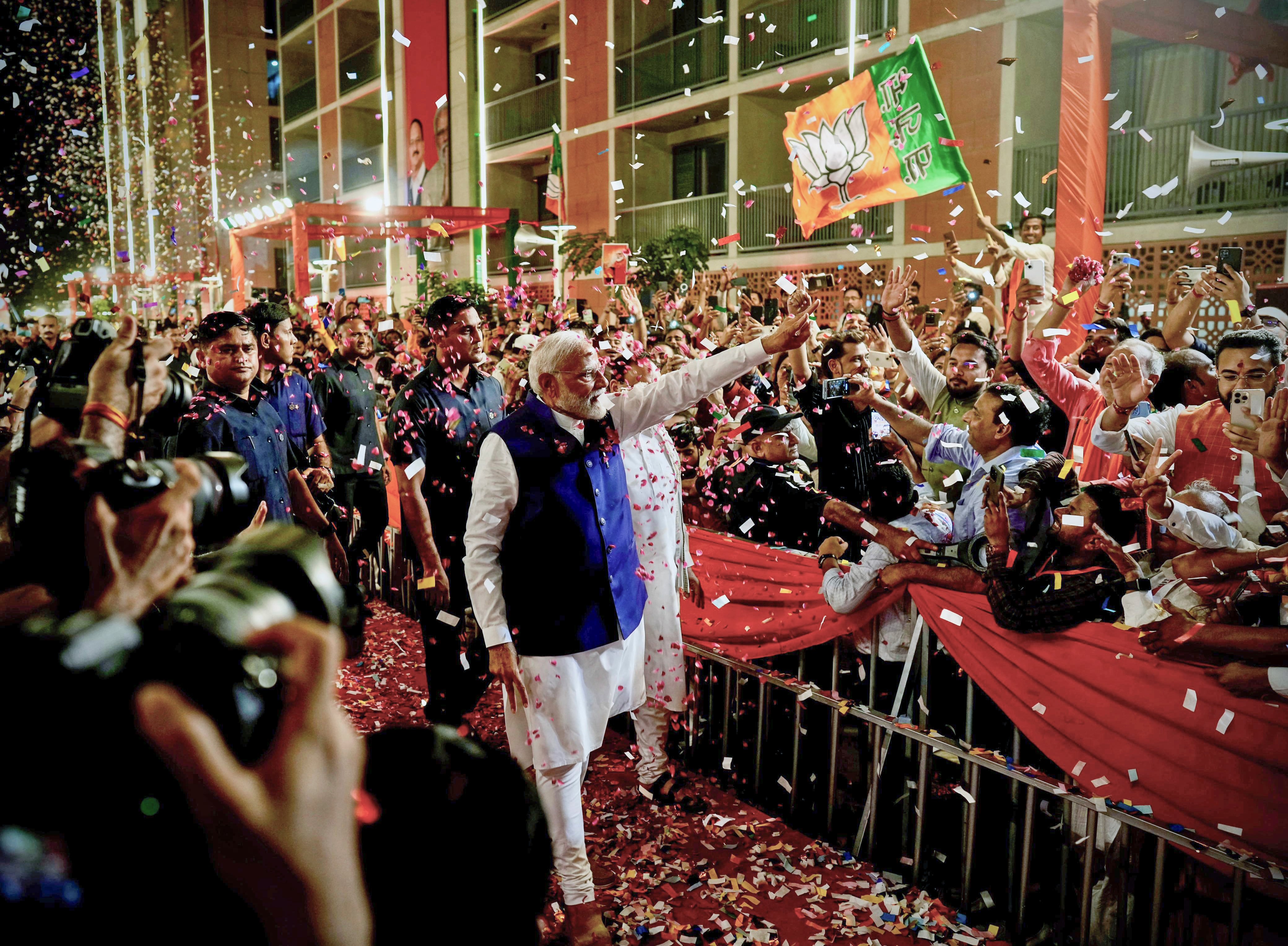 Prime Minister Narendra Modi is greeted by supporters as he arrives at Bharatiya Janata Party headquarters in New Delhi, India, Tuesday. Indian voters turned out in record numbers despite heatwaves and cyclones to elect their chief executive.
