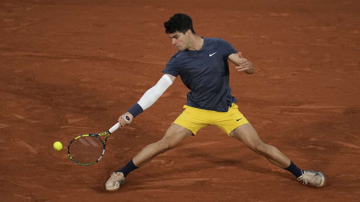 Spain's Carlos Alcaraz plays a shot against Greece's Stefanos Tsitsipas during their quarterfinal match of the French Open tennis tournament at the Roland Garros stadium in Paris, Tuesday, June 4, 2024.