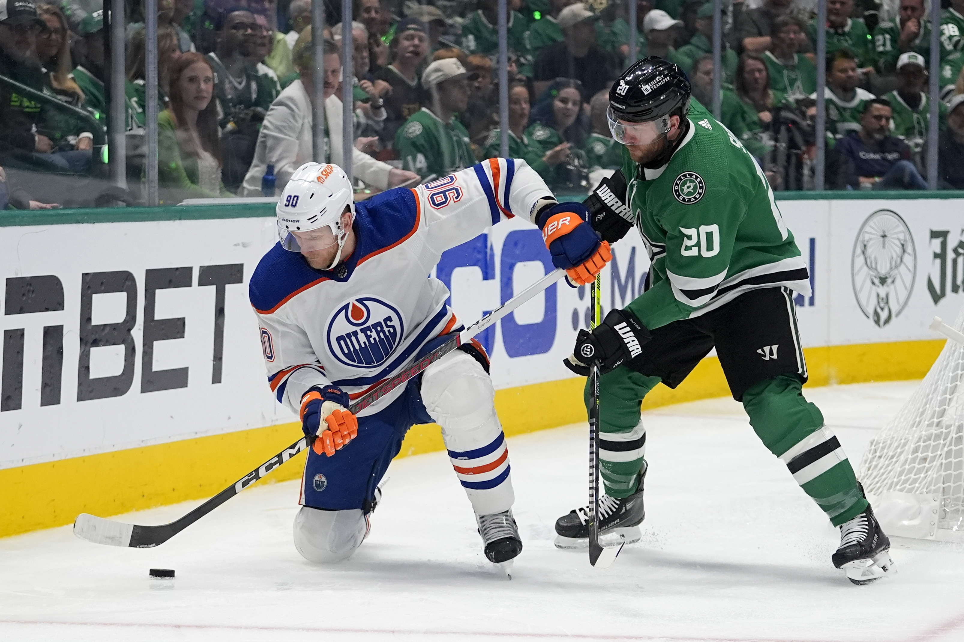 Edmonton Oilers right wing Corey Perry (90) looks to take control of the puck in front of Dallas Stars defenseman Ryan Suter (20) during the second period of Game 5 of the Western Conference finals in the NHL hockey Stanley Cup playoffs Friday, May 31, 2024, in Dallas. 