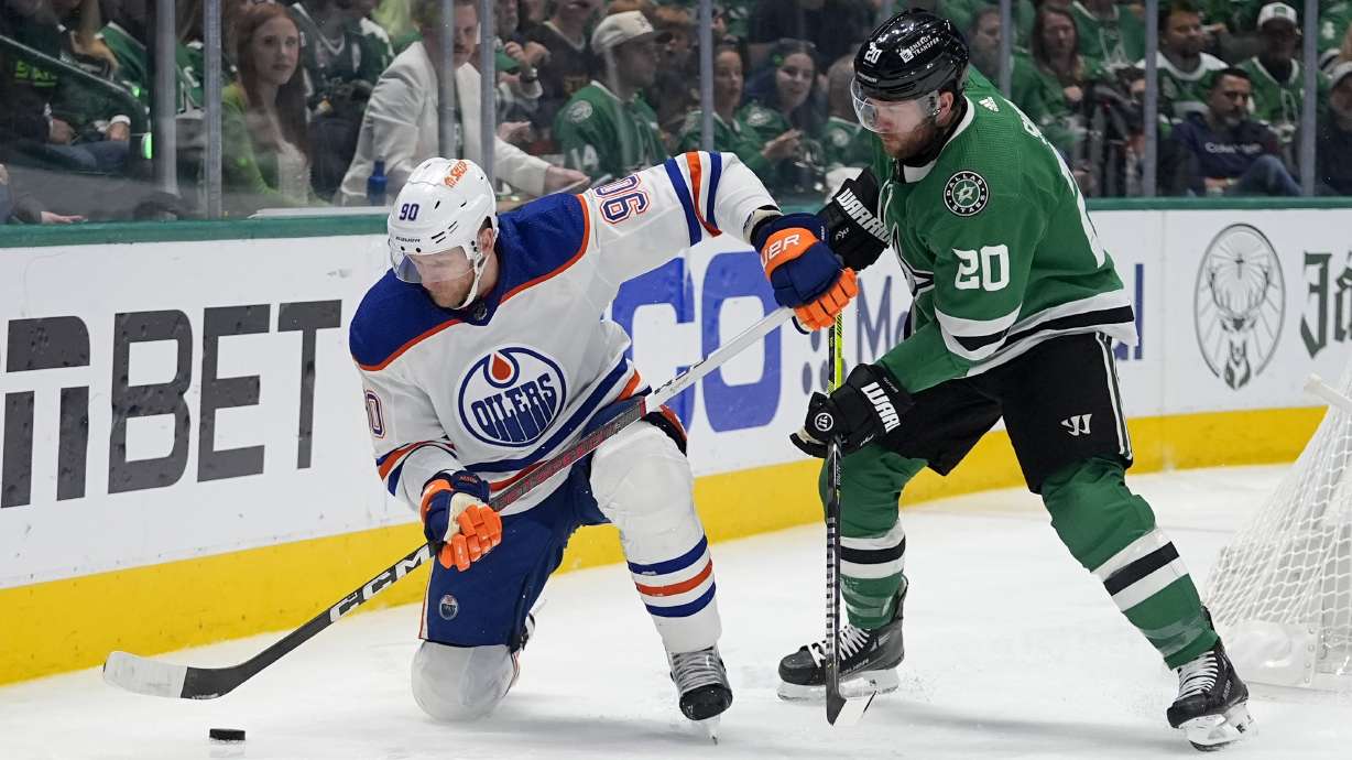 Edmonton Oilers right wing Corey Perry (90) looks to take control of the puck in front of Dallas Stars defenseman Ryan Suter (20) during the second period of Game 5 of the Western Conference finals in the NHL hockey Stanley Cup playoffs Friday, May 31, 2024, in Dallas.