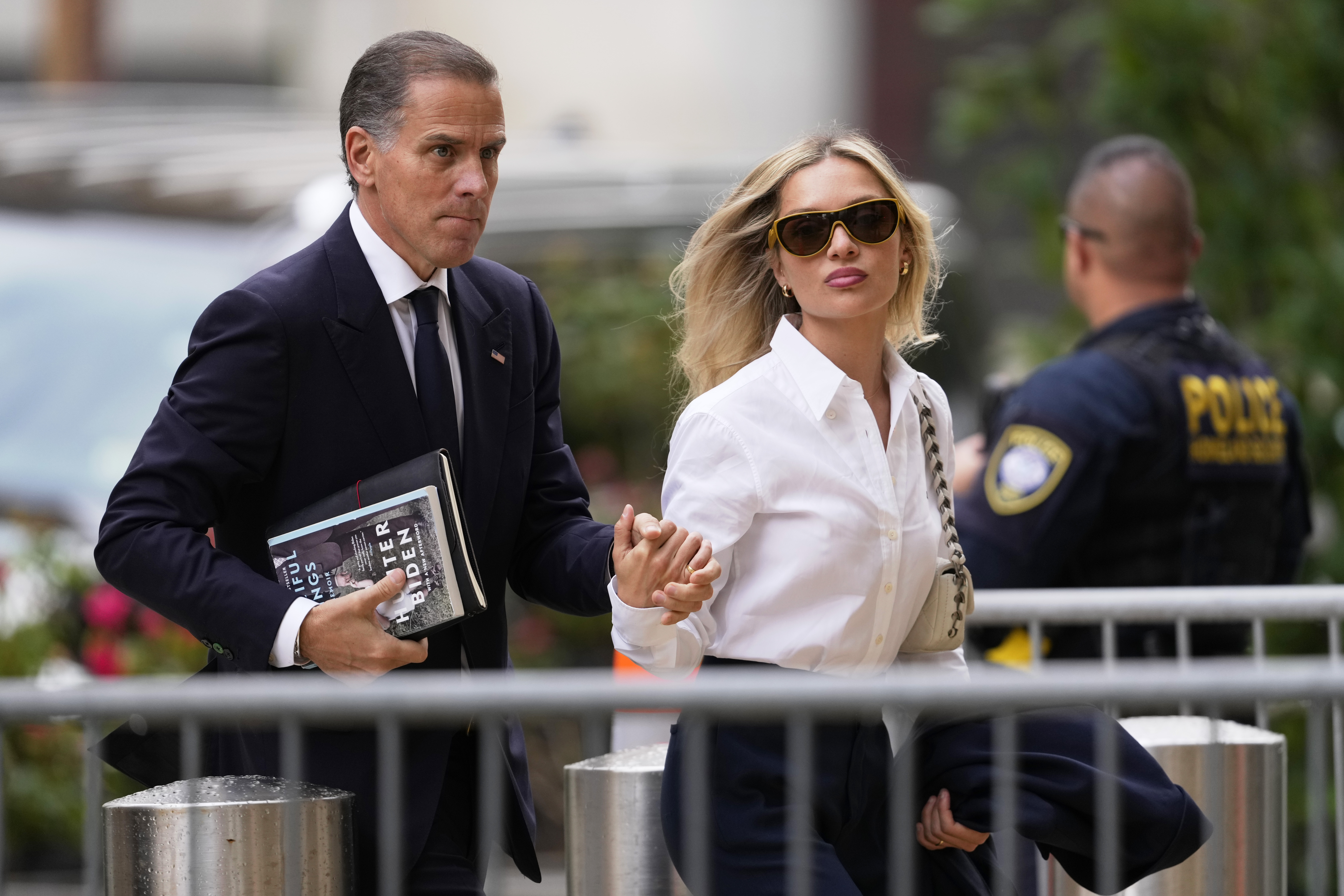 Hunter Biden, left, arrives to federal court with his wife, Melissa Cohen Biden, Thursday, in Wilmington, Del. Prosecutors are expected to rest their case against Hunter Biden on Thursday.