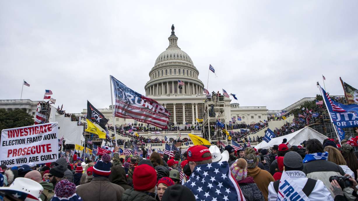 FILE - Rioters loyal to President Donald Trump rally at the U.S. Capitol in Washington, Jan. 6, 2021. Retired NASCAR driver Tighe Scott, his adult son and two other Pennsylvania men are facing felony charges stemming from confrontations with police during the Jan. 6, 2021, siege on the U.S. Capitol.