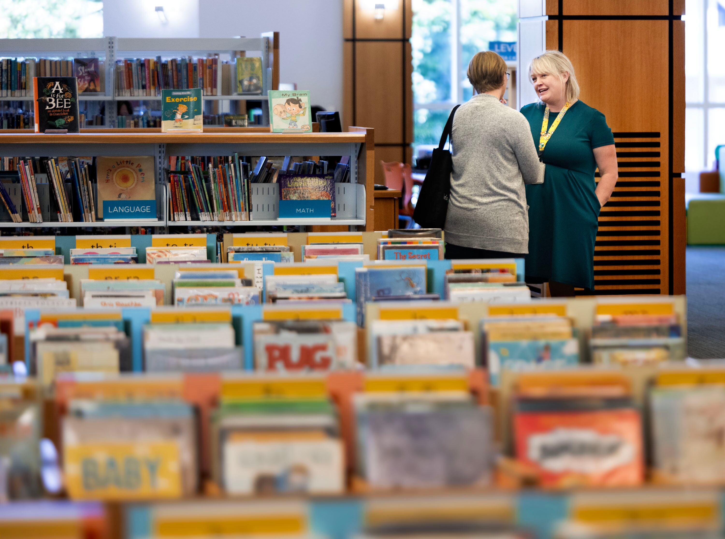 Kim Christensen, librarian at Springville Library, right, speaks with a patron at the Springville Public Library on Thursday. Christensen is one of eight librarians nationwide selected to meet Jeff Kinney, author of the internationally bestselling Diary of a Wimpy Kid series.