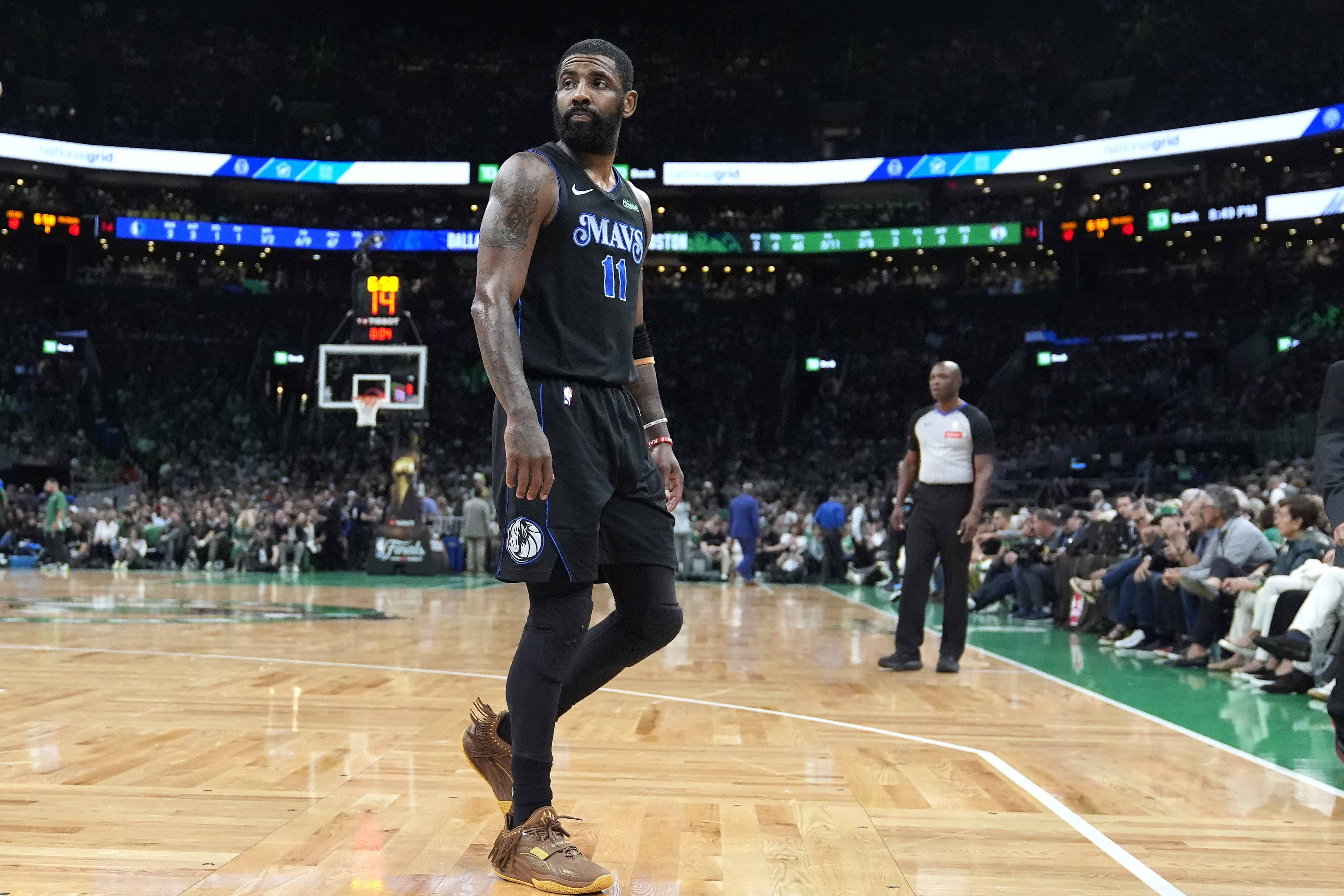 Dallas Mavericks guard Kyrie Irving heads toward the bench during the first half of Game 1 of the basketball team's NBA Finals against the Boston Celtics, Thursday, June 6, 2024, in Boston. 