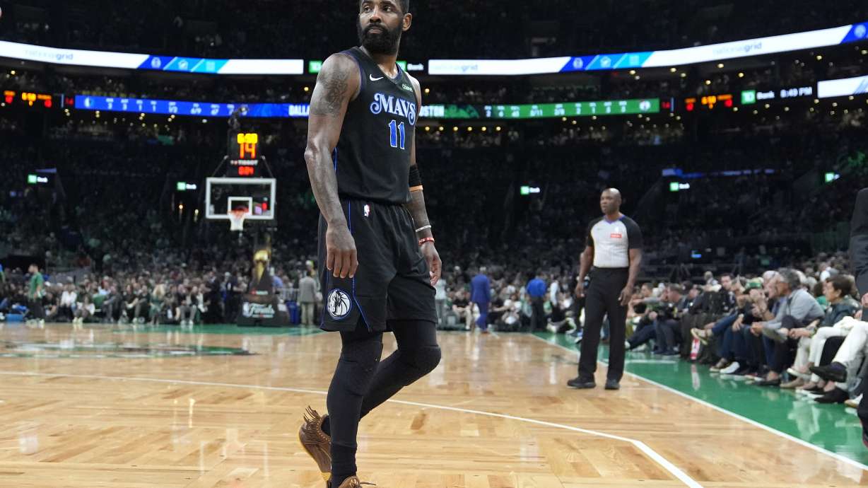 Dallas Mavericks guard Kyrie Irving heads toward the bench during the first half of Game 1 of the basketball team's NBA Finals against the Boston Celtics, Thursday, June 6, 2024, in Boston.