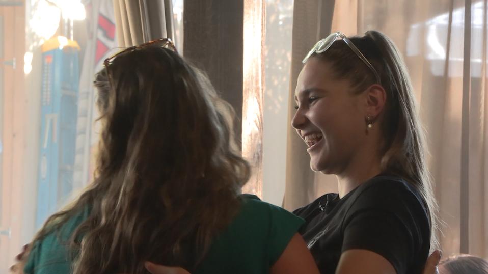 Deirdre Babcock, right, hugs and laughs with another customer she knows at Garage on Beck in Salt Lake City on Thursday. The popular bar recently reopened after a devastating fire.