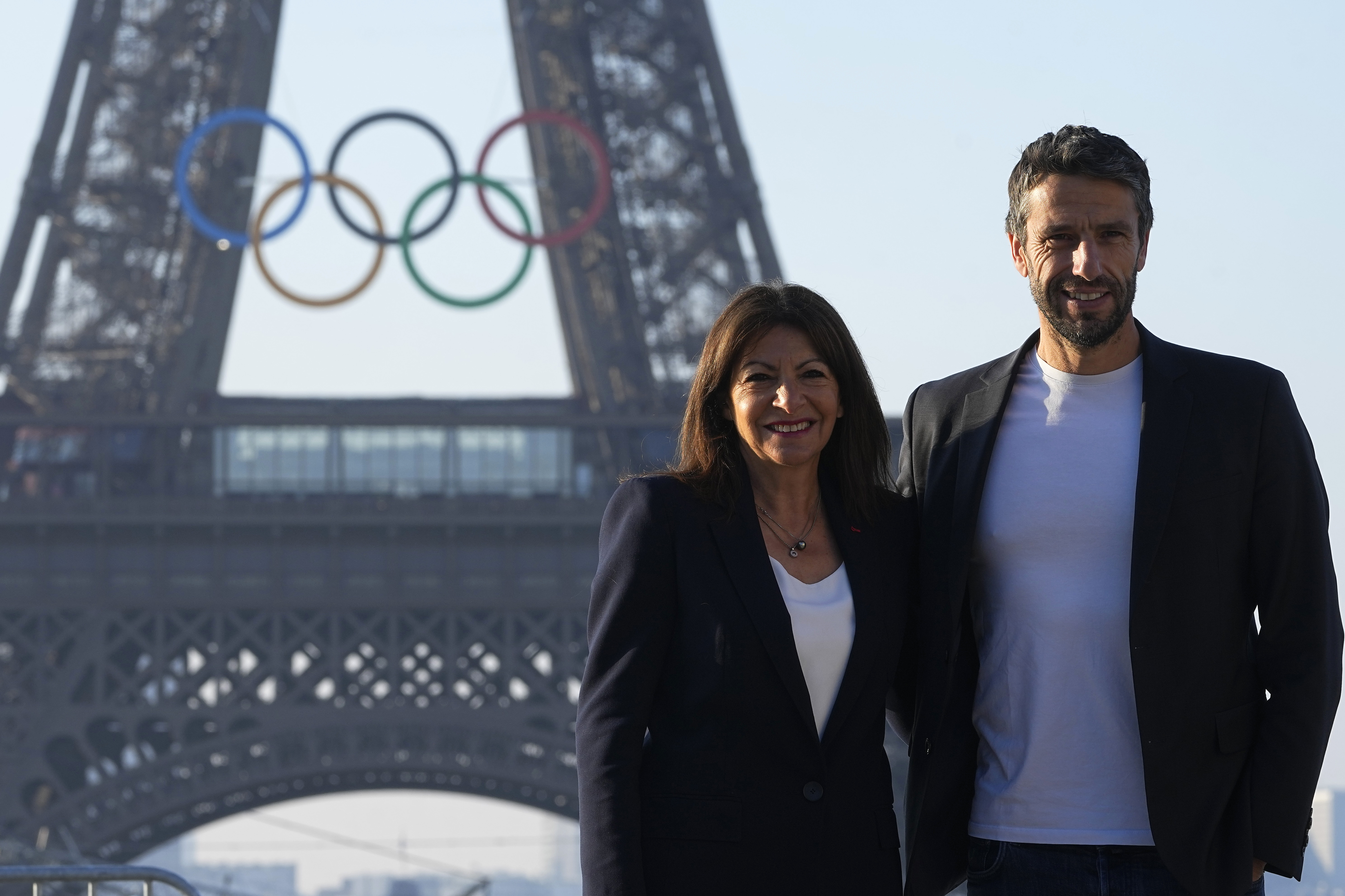Paris mayor Anne Hidalgo and head of Paris 2024 Olympics pose in front of the Eiffel Tower Friday, June 7, 2024 in Paris. The Paris Olympics organizers mounted the rings on the Eiffel Tower on Friday as the French capital marks 50 days until the start of the Summer Games. The 95-foot-long and 43-foot-high structure of five rings, made entirely of recycled French steel, will be displayed on the south side of the 135-year-old historic landmark in central Paris, overlooking the Seine River. 