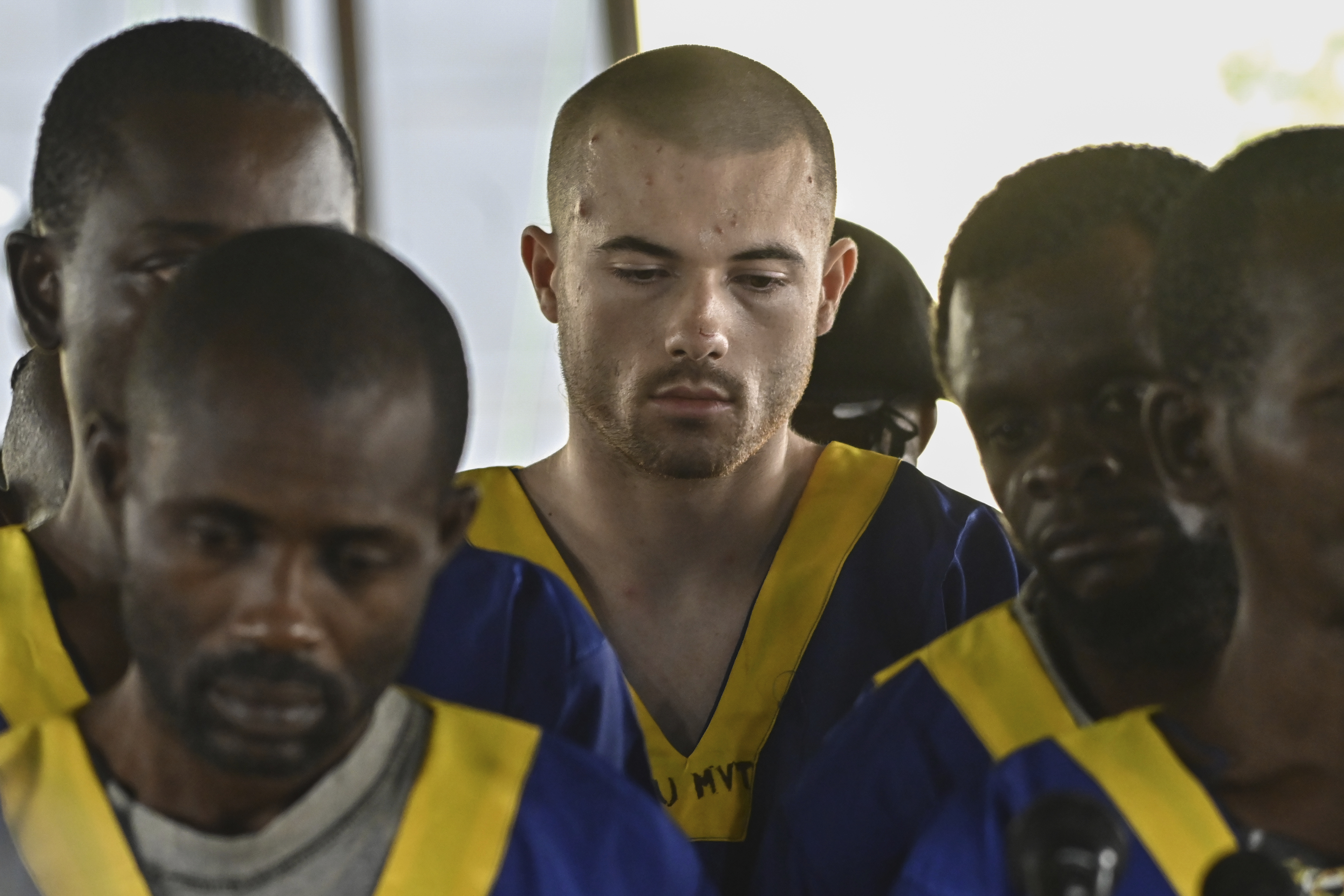 American Tyler Thompson Jr., center, sits in court in Kinshasa, Friday. Three Americans accused of a role in last month's attempted coup in Congo appeared in court in Kinshasa on Friday, among a total of 53 defendants.