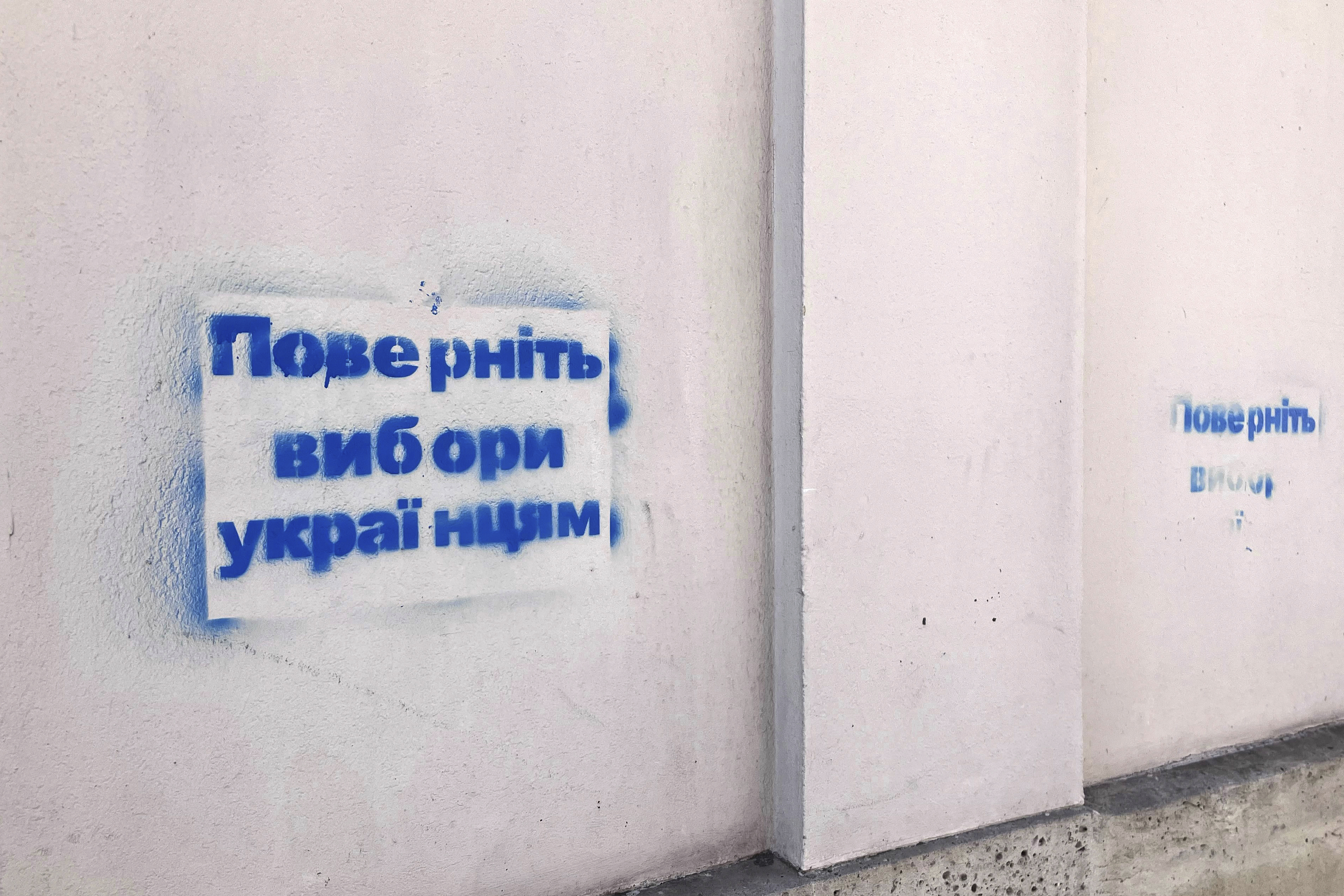 A graffiti reading "Return the elections to the Ukrainians", in Ukrainian, is seen in Paris Friday, June 7, 2024 in Paris. Unusual spraypainted images and messages with references to Ukraine have appeared on the streets of Paris on Friday as Ukrainian President Volodymyr Zelenskyy met with U.S. President Joe Biden in the French capital.