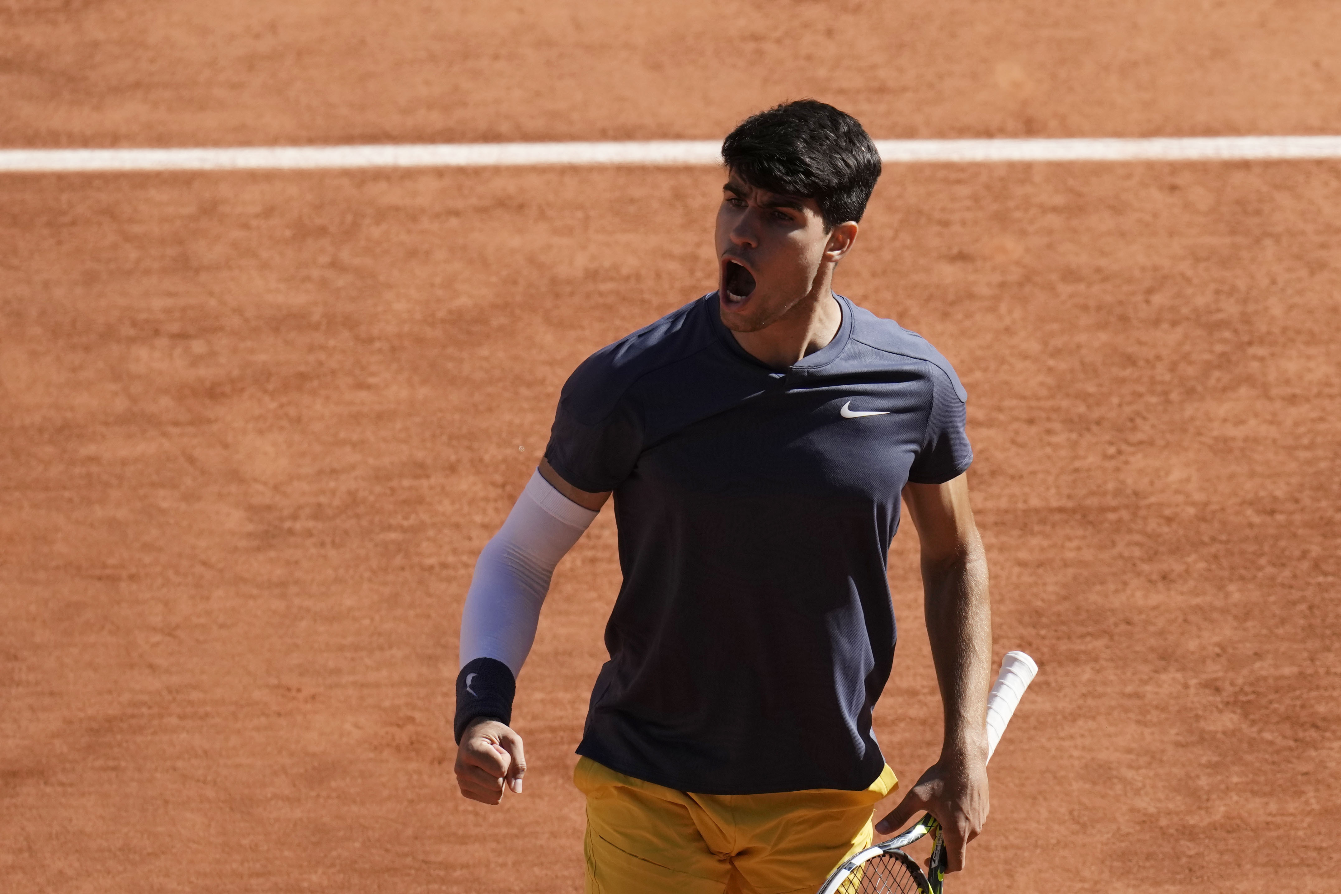 Spain's Carlos Alcaraz reacts during his semifinal match of the French Open tennis tournament against Italy's Jannik Sinner at the Roland Garros stadium in Paris, Friday, June 7, 2024. 