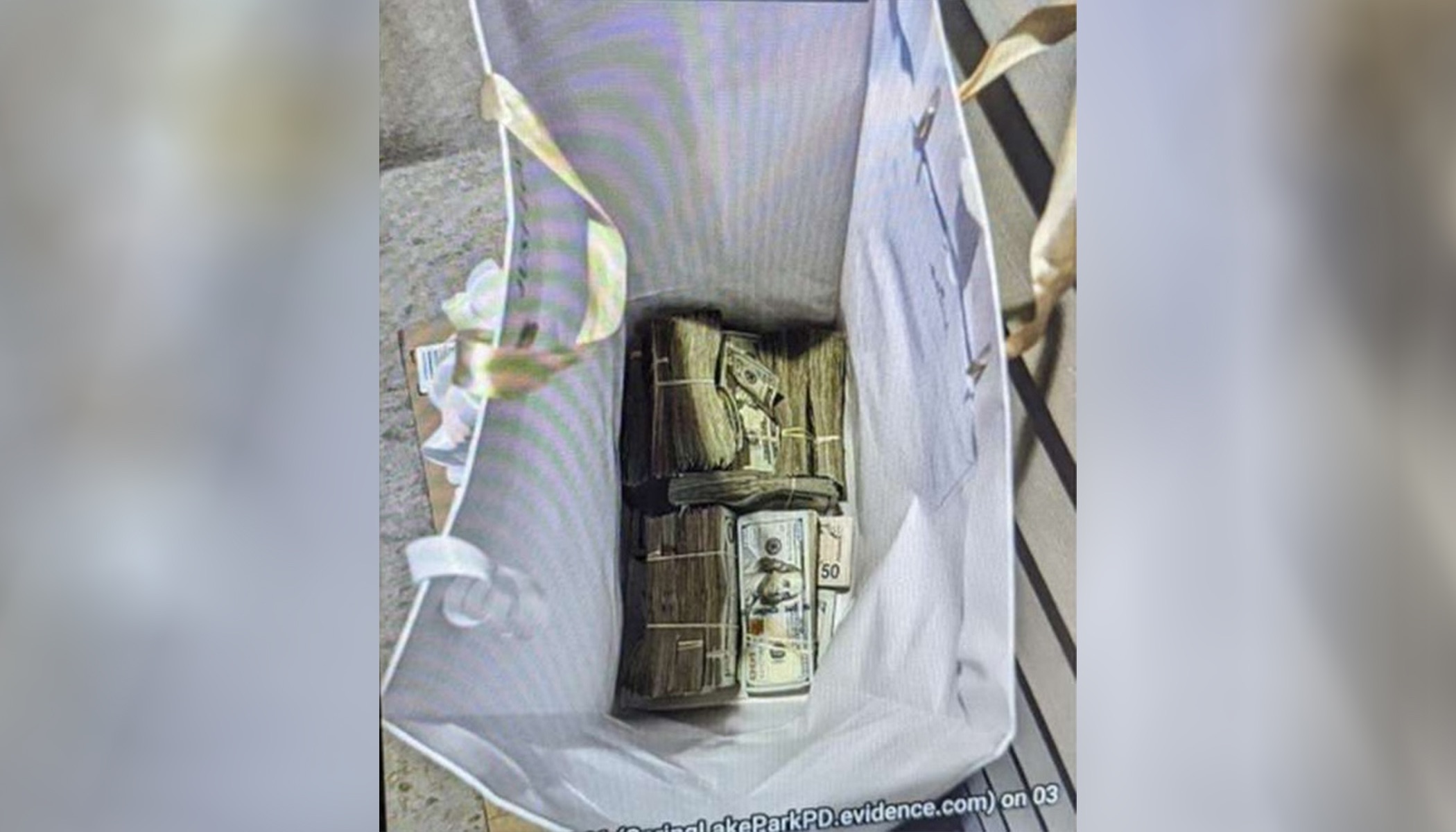 This photo shows cash from a bag that was left at the home of a juror in a massive fraud case, Sunday outside Minneapolis, Minn. Five of seven defendants were convicted.