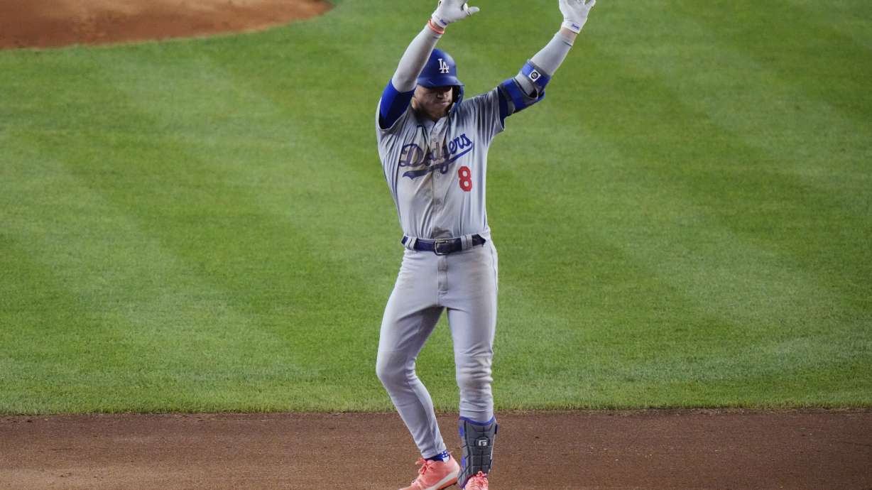 Los Angeles Dodgers' Kiké Hernández (8) gestures to fans after hitting a double during the seventh inning of a baseball game against the New York Yankees, Friday, June 7, 2024, in New York.