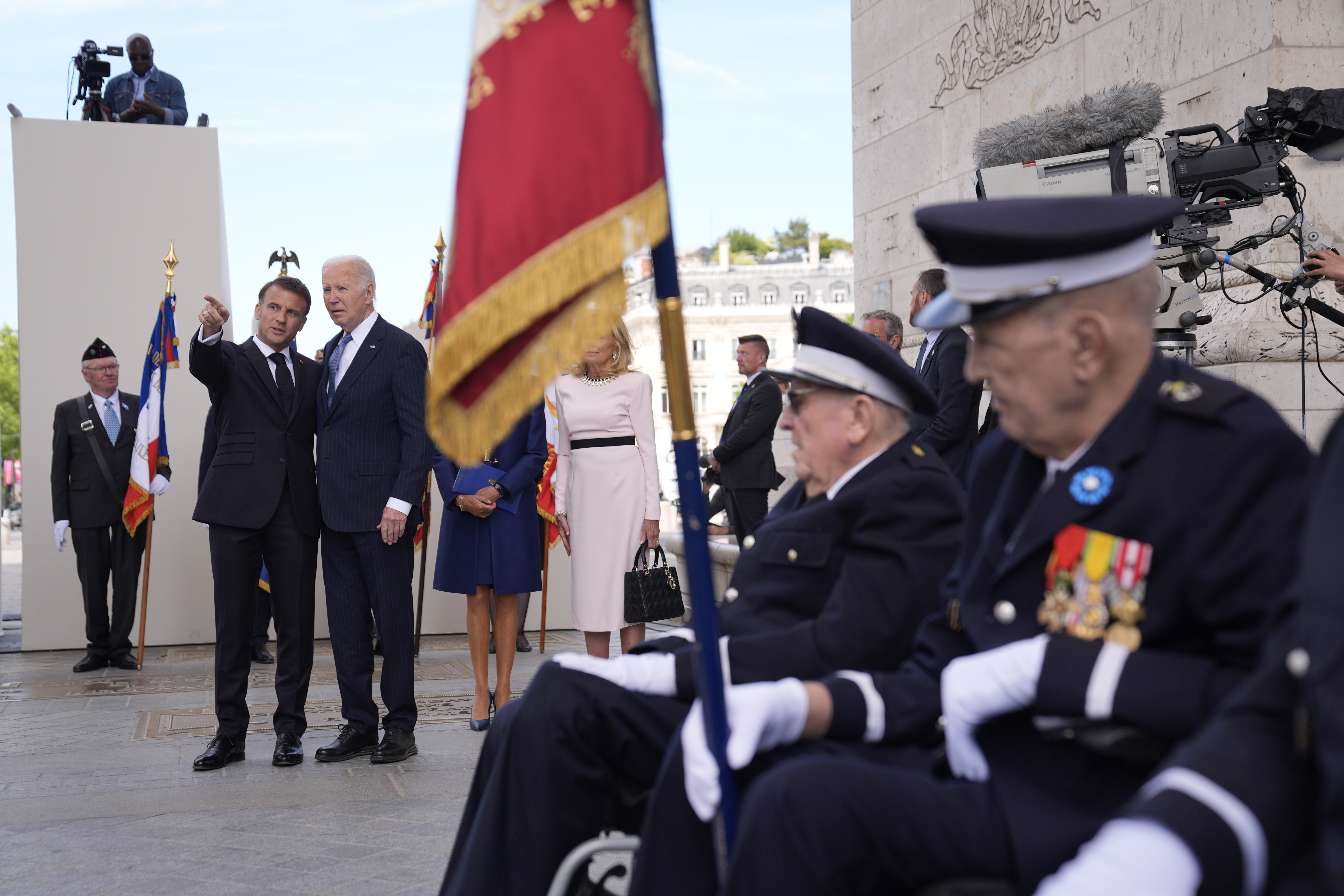 U.S. President Joe Biden and French President Emmanuel Macron speak, during a ceremony at the tomb of the unknown soldier under the Arc de Triomphe, Saturday, in Paris.