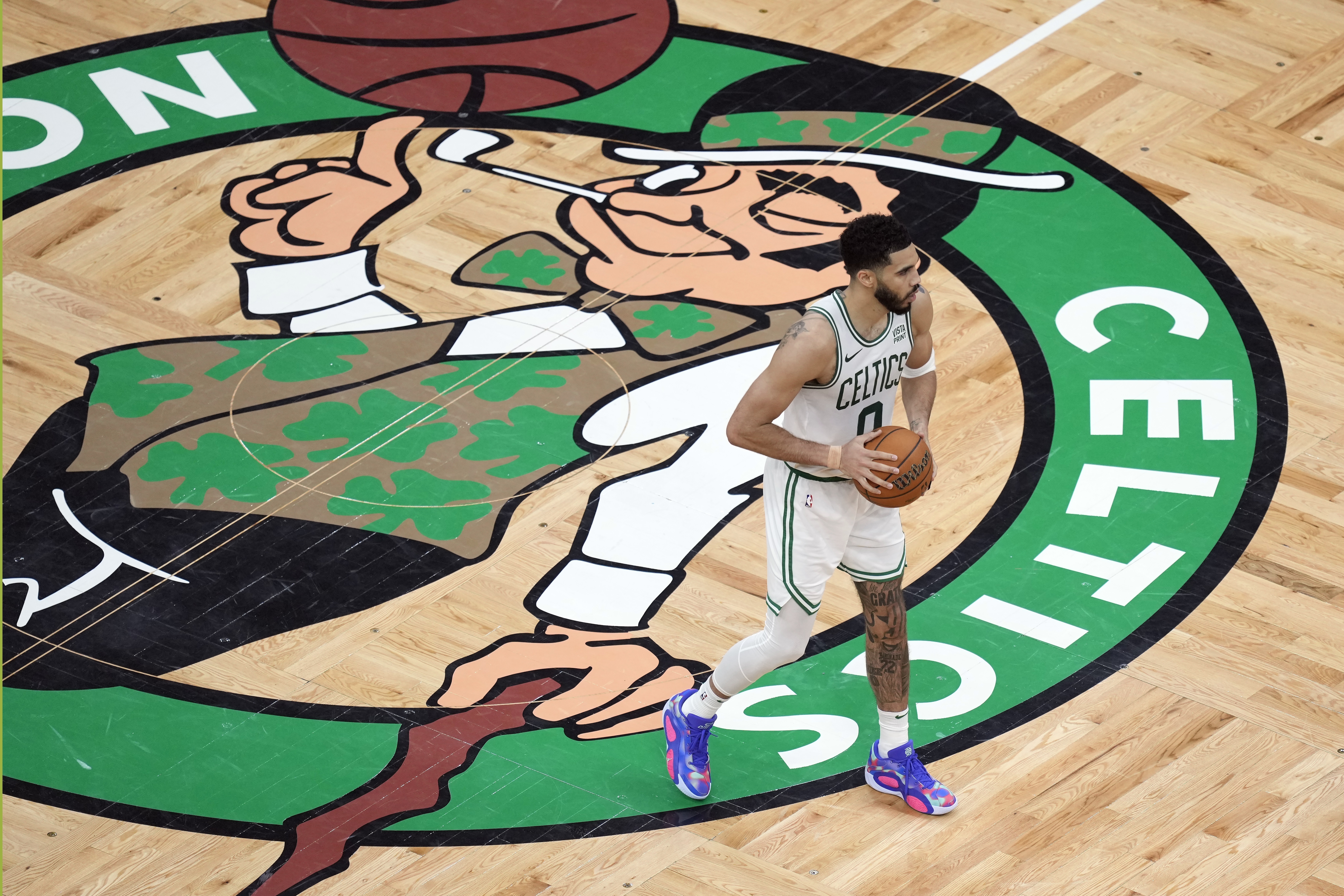 Boston Celtics' Jayson Tatum (0) holds the ball near midcourt during the second half of Game 1 of the basketball team's NBA Finals against the Dallas Mavericks on Thursday, June 6, 2024, in Boston.