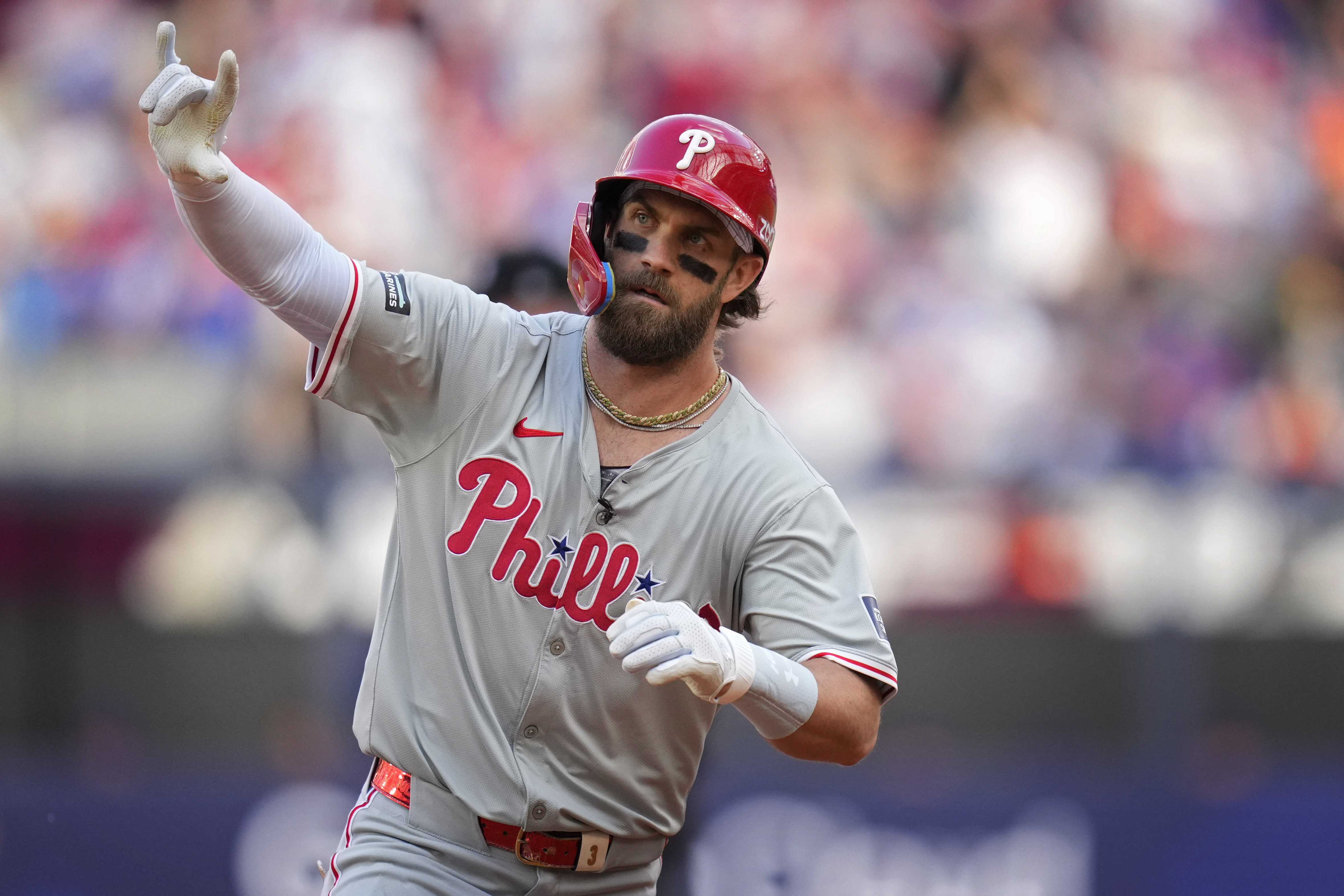 Philadelphia Phillies' Bryce Harper (3) celebrates as he rounds the bases after hitting a home run against the New York Mets during the fourth inning of a London Series baseball game in London, Saturday, June 8, 2024. 