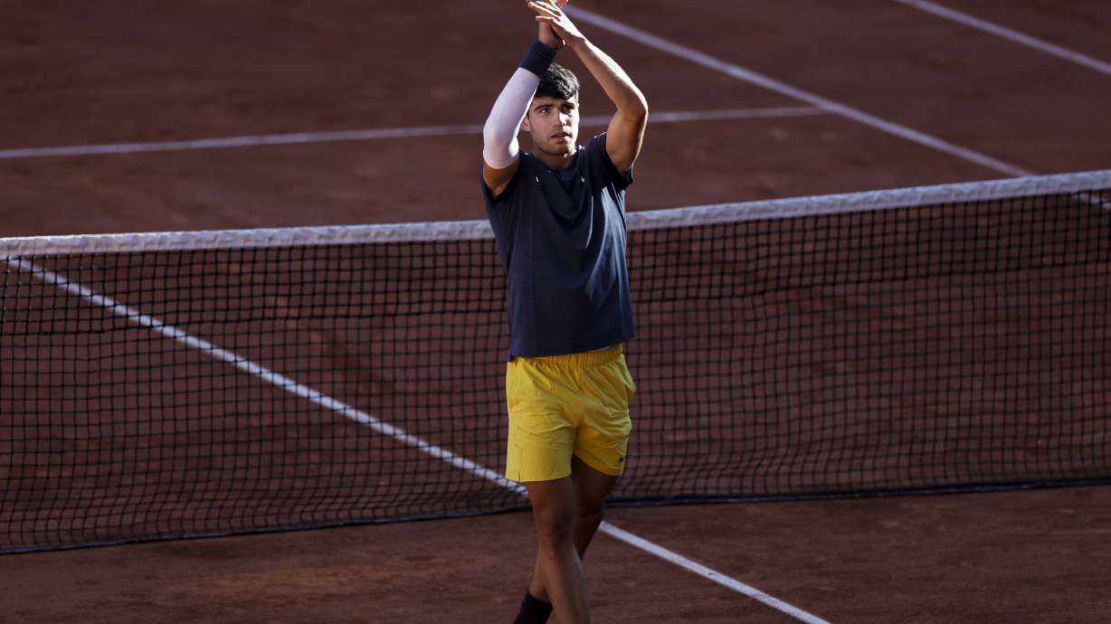 Spain's Carlos Alcaraz celebrates as he won the semifinal match of the French Open tennis tournament against Italy's Jannik Sinner at the Roland Garros stadium in Paris, Friday, June 7, 2024.