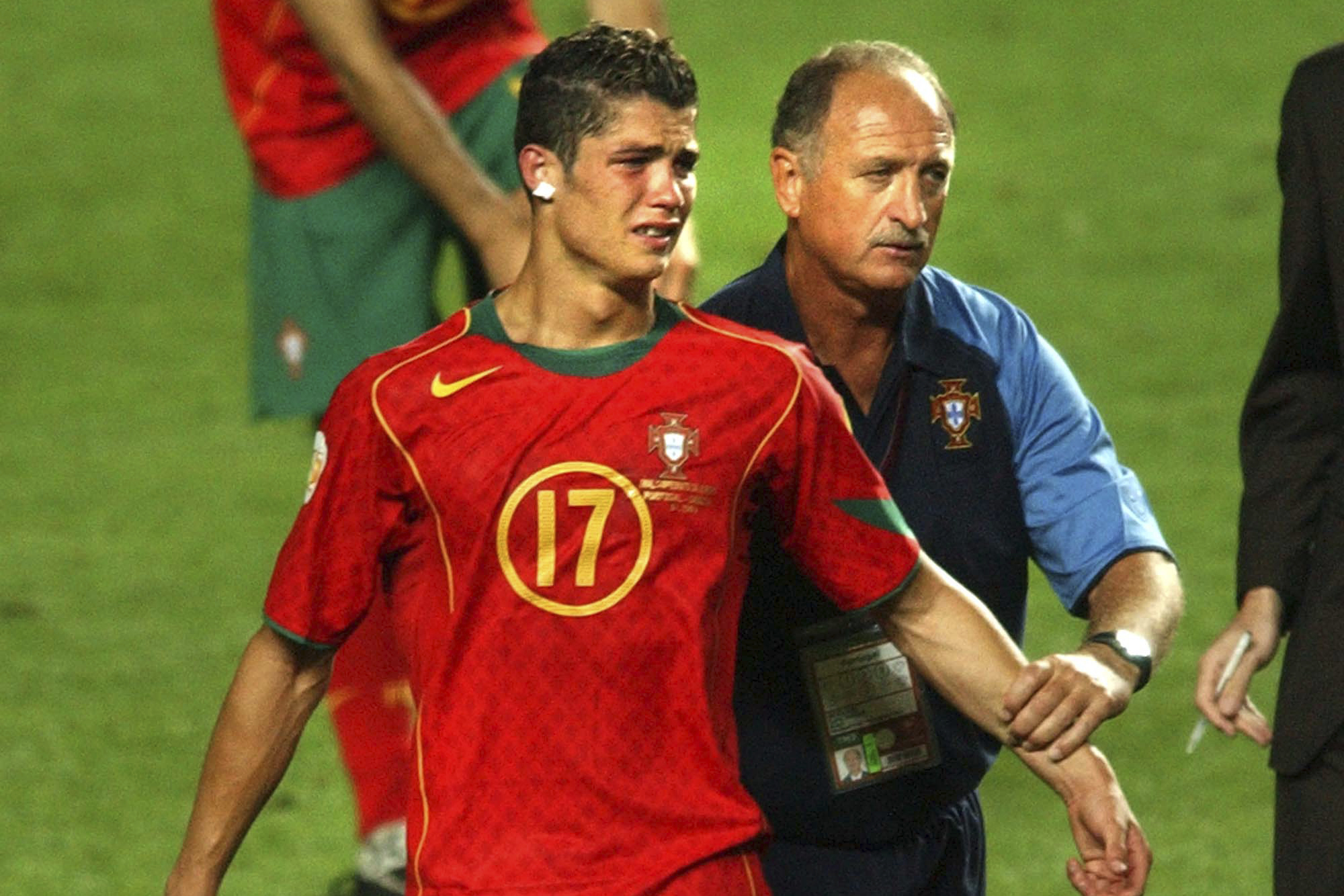 FILE - Portugal coach Luiz Felipe Scolari, right, leads a tearful Cristiano Ronaldo to collect his runners-up medal after Greece beat Portugal 1-0 in the Euro 2004 soccer championship final match at the Luz stadium in Lisbon, Portugal, Sunday, July 4, 2004. Portugal's Cristiano Ronaldo and Croatia's Modric go to Euro 2024 showing age is no boundary for soccer's modern stars. 