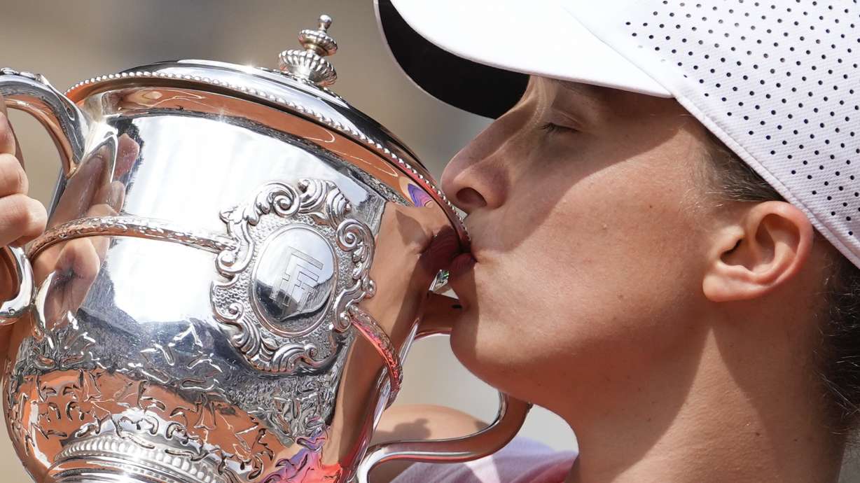 Poland's Iga Swiatek kisses the trophy after winning the women's final of the French Open tennis tournament against Italy's Jasmine Paolini at the Roland Garros stadium in Paris, France, Saturday, June 8, 2024.