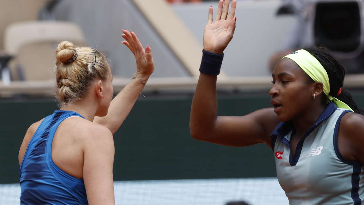 Coco Gauff of the U.S., right, and Katerina Siniakova of the Czech Republic celebrate winning a point against Italy's Sara Errani and Jasmine Paolini during the women's doubles final match of the French Open tennis tournament at the Roland Garros stadium in Paris, Sunday, June 9, 2024.