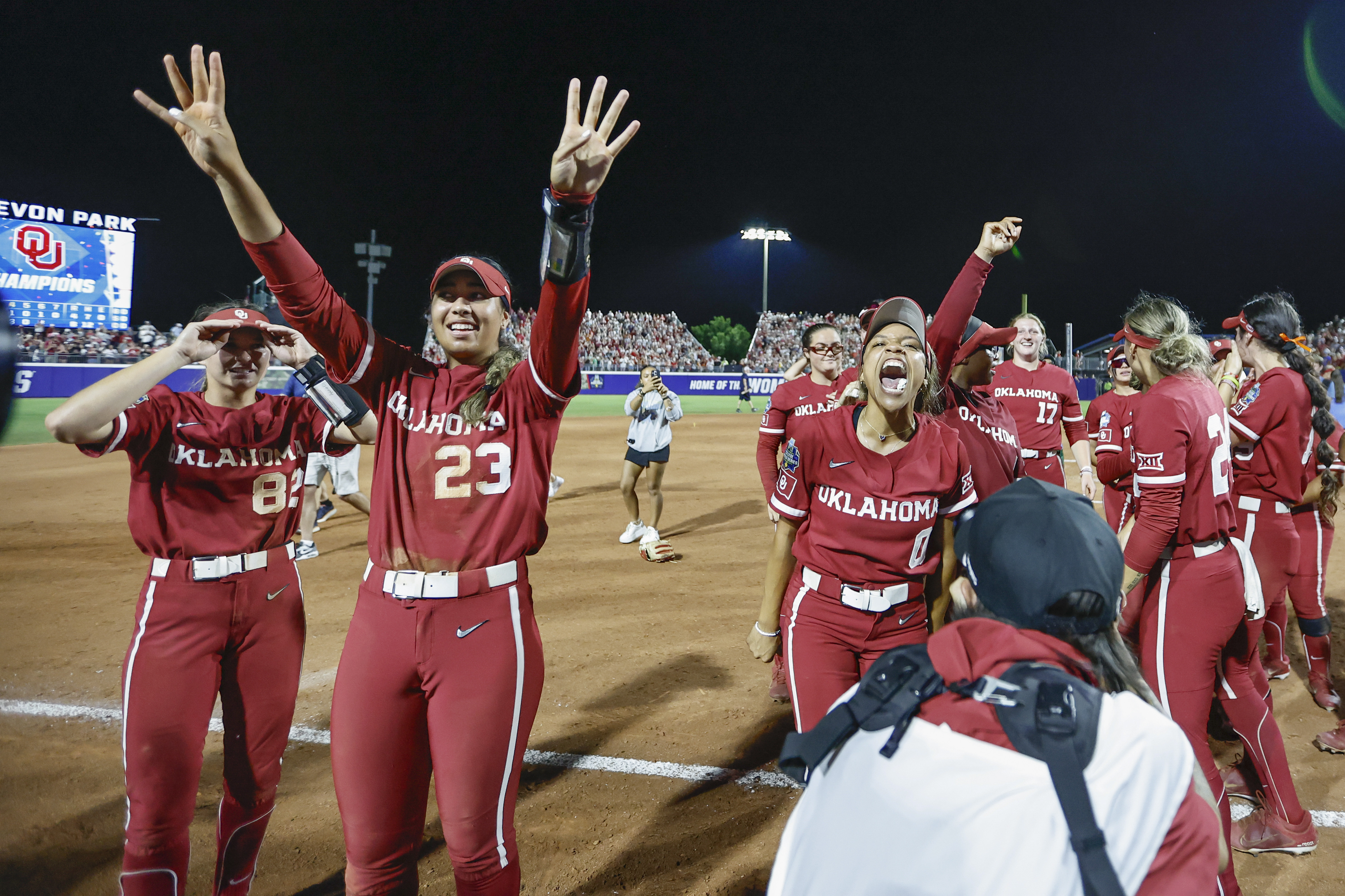 Oklahoma's Tiare Jennings (23), Rylie Boone (0) and Avery Hodge (82) celebrate the team's win over Texas in the NCAA Women's College World Series softball championship series Thursday, June 6, 2024, in Oklahoma City. 