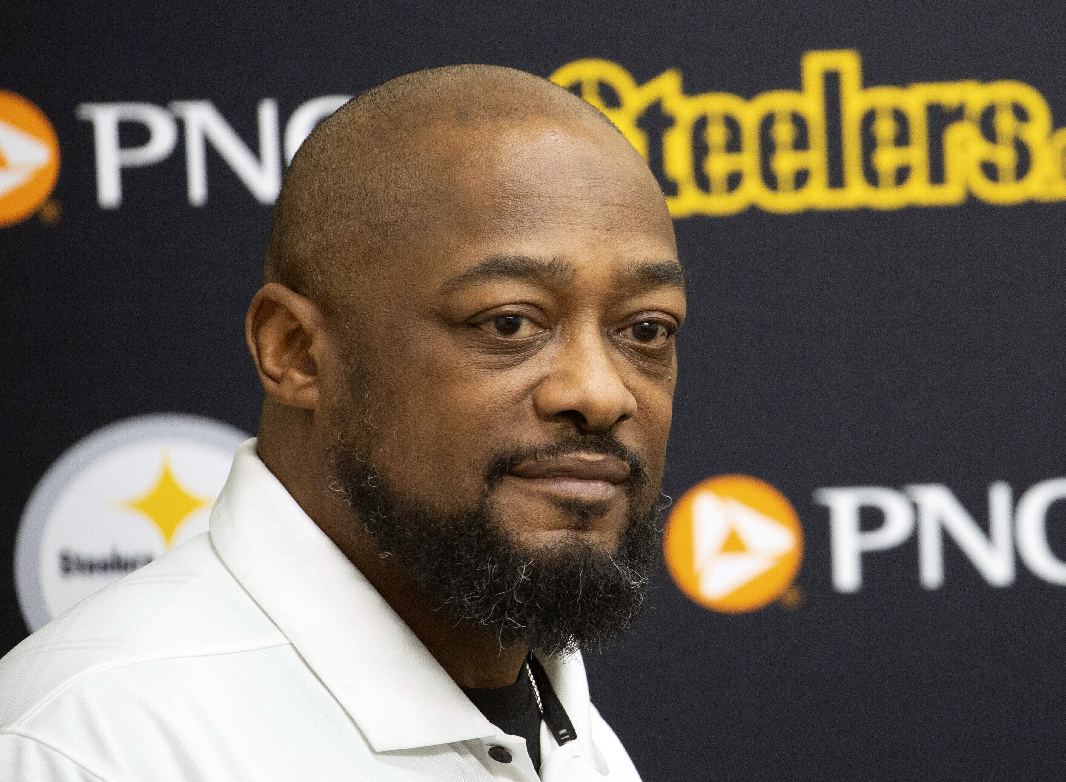 FILE - Pittsburgh Steelers head coach Mike Tomlin listens during a press conference in Pittsburgh, Friday, March 15, 2024. Tomlin signed an extension with the Steelers on Monday, June 10, that will keep the NFL's longest-tenured coach in Pittsburgh through at least 2027. 