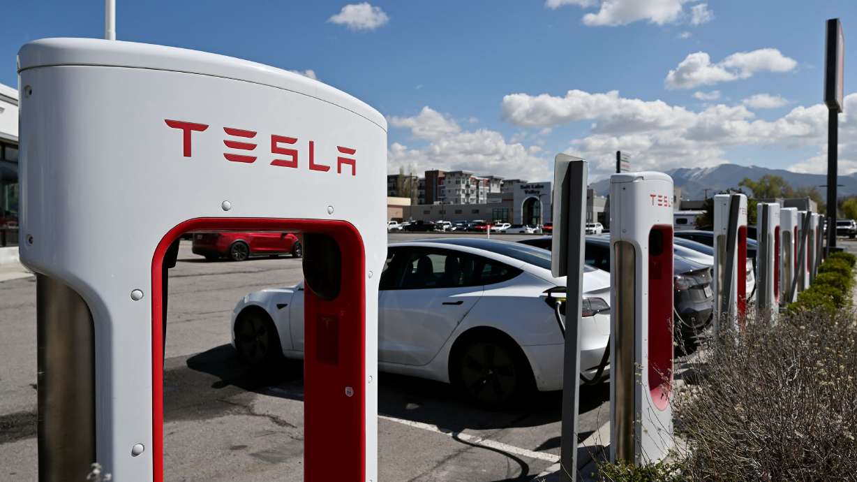 Tesla chargers are pictured at the dealership in Salt Lake City on April 16. A recent AAA survey found that Americans are less attracted to switching out their gas gusler for an electric vehicle than last year.