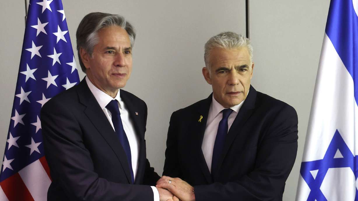 U.S. Secretary of State Antony Blinken, left, shakes hands with Israeli opposition leader Yair Lapid during a meeting in Tel Aviv Tuesday. Blinken has called on Hamas to accept a U.S.-backed proposal for a Gaza cease-fire and hostage release.
