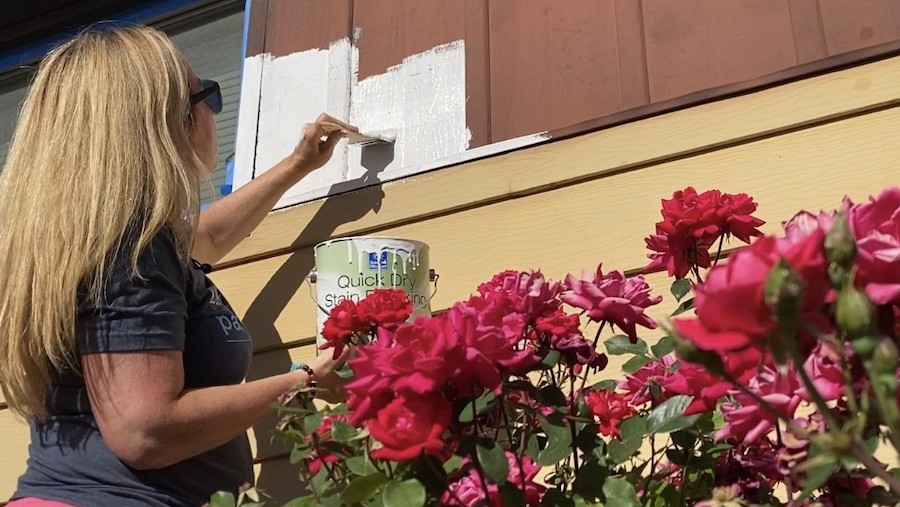 Several volunteers helped paint the home of Randy and Virginia Nielsen as part of the 32nd annual Zions Bank Paint-a-Thon service project on Monday in West Valley City.