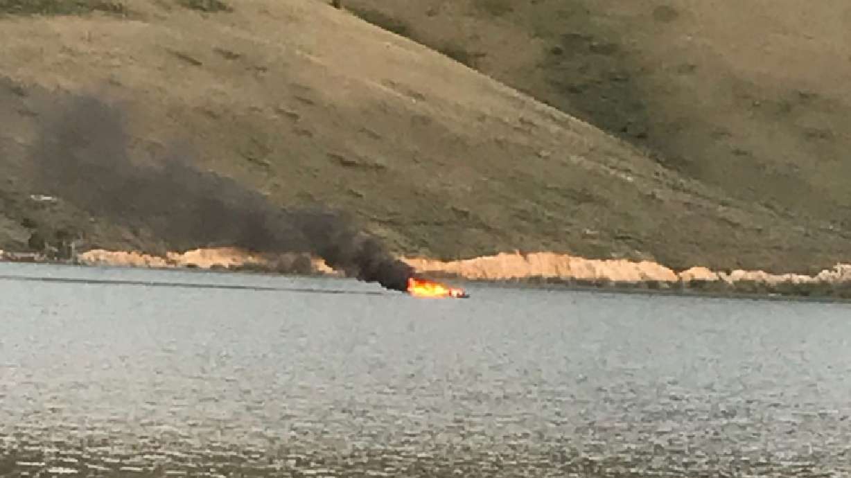A boat was on fire at the Mackay Reservoir in Idaho on Friday. Two people were rescued after the boat they were on exploded and then caught fire.