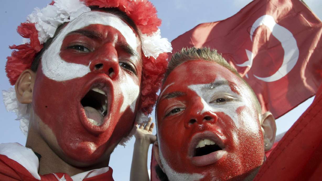 FILE -Turkey's fans celebrate at the KoelnArena-Dome prior to the soccer EURO 2008 semi-final match between Germany and Turkey in Cologne, western Germany, Thursday afternoon, June 25, 2008. “In Germany we’re going to be like a host country,” Turkey defender Ozan Kabak, who was born in Turkey but plays his club soccer in Germany, said in a recent interview. “A lot of Turkish people live here, and I think whole stadiums (are) going to be full of Turkish people." Fans of the Turkish team even outnumbered Germany’s supporters at the friendly in Berlin last year.