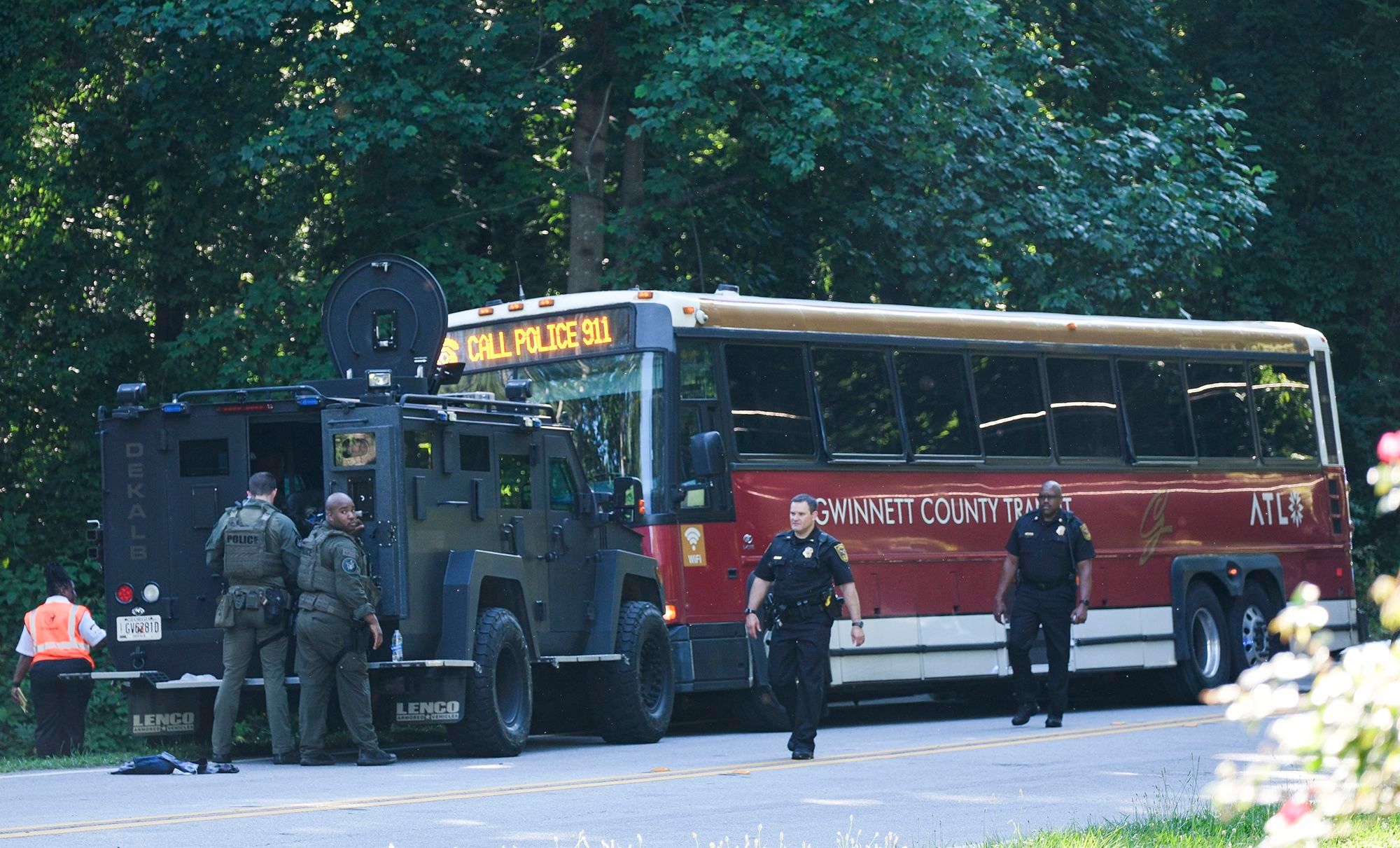 A hijacked commuter bus sits on an Atlanta road where it was stopped after a lengthy police chase on Tuesday.