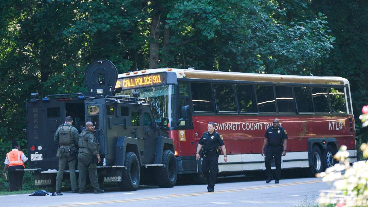 A hijacked commuter bus sits on an Atlanta road where it was stopped after a lengthy police chase on Tuesday.