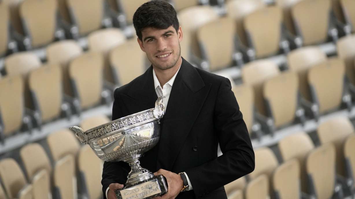 Spain's Carlos Alcaraz holds the trophy as he poses for media after the French Open tennis tournament at the Roland Garros stadium in Paris, Monday, June 10, 2024. Alcaraz won the title on Sunday in the final against Germany's Alexander Zverev.