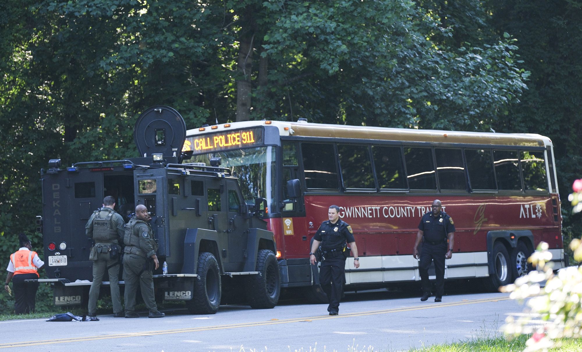 A hijacked commuter bus sits in the road where it was stopped after a lengthy police chase on Tuesday.