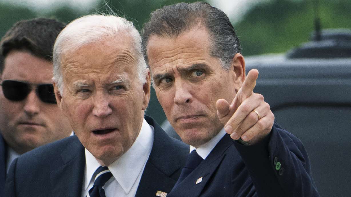 President Joe Biden talks with his son Hunter Biden as he arrives Delaware Air National Guard Base in New Castle, Del., Tuesday. The White House isn't ruling out a potential commutation for Hunter Biden.