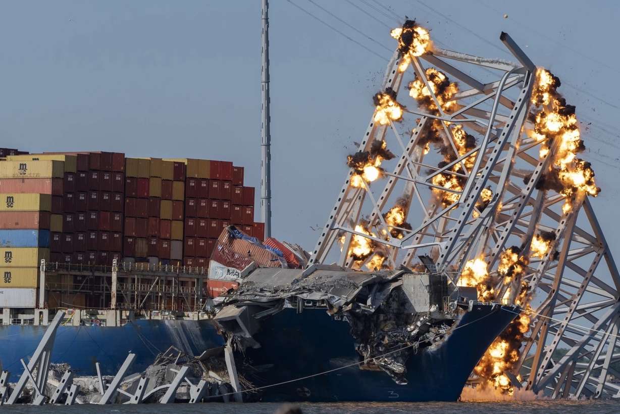 Explosive charges are detonated to bring down sections of the collapsed Francis Scott Key Bridge resting on the container ship Dali on May 13 in Baltimore.